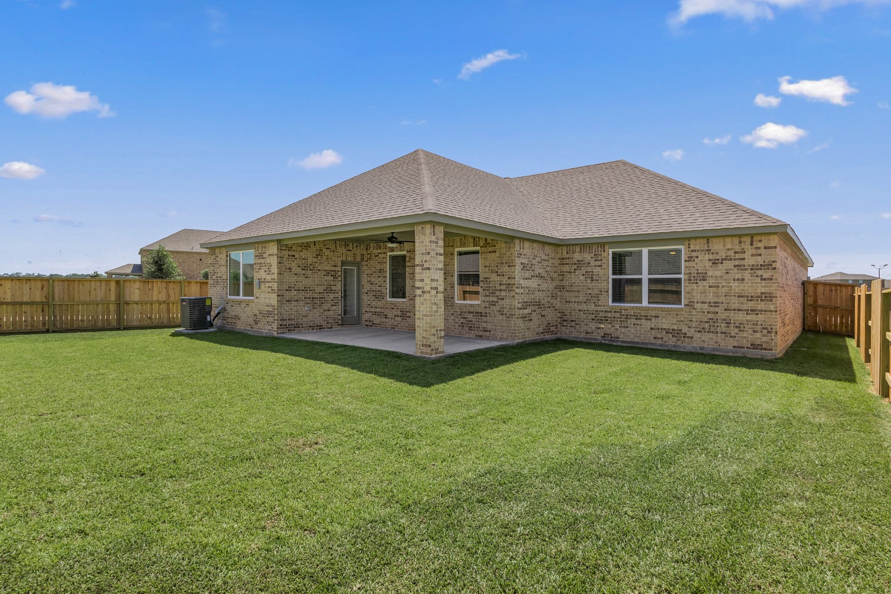 The spacious covered patio is perfect for outdoor entertaining. Photo is for example purpose. Brick color may be different than example photo.