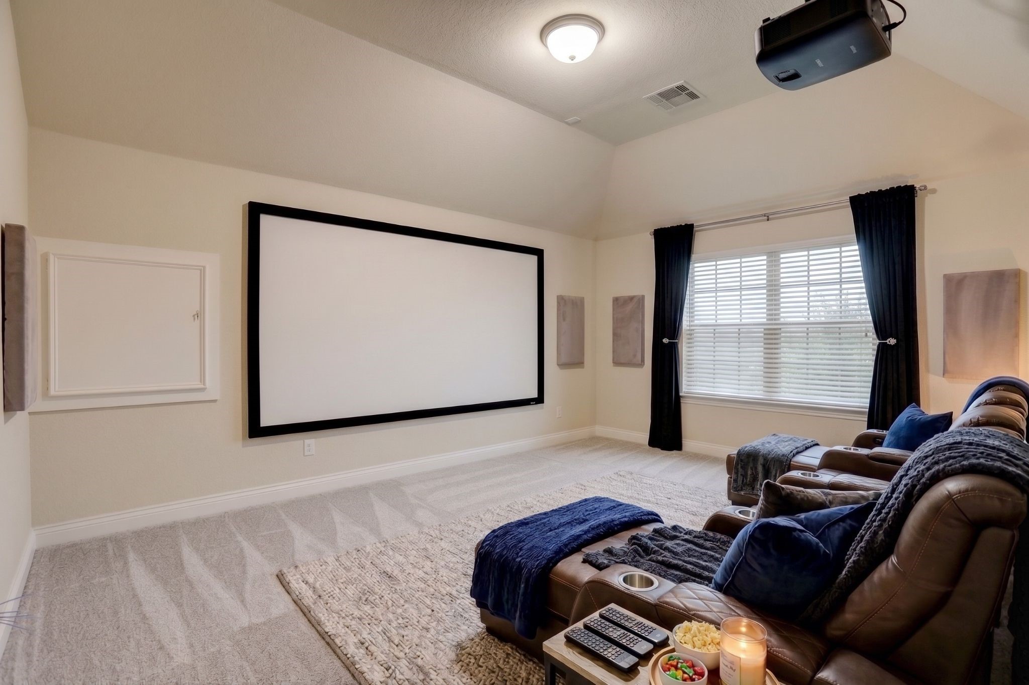 *Virtually Staged*Designed for the ultimate movie night, this dedicated media room offers the perfect space to enjoy blockbuster films, game-day watch parties, or your favorite streaming series. With room for comfortable theater seating and a large projection screen, it's an ideal retreat for entertaining family and friends or creating unforgettable at home experiences.