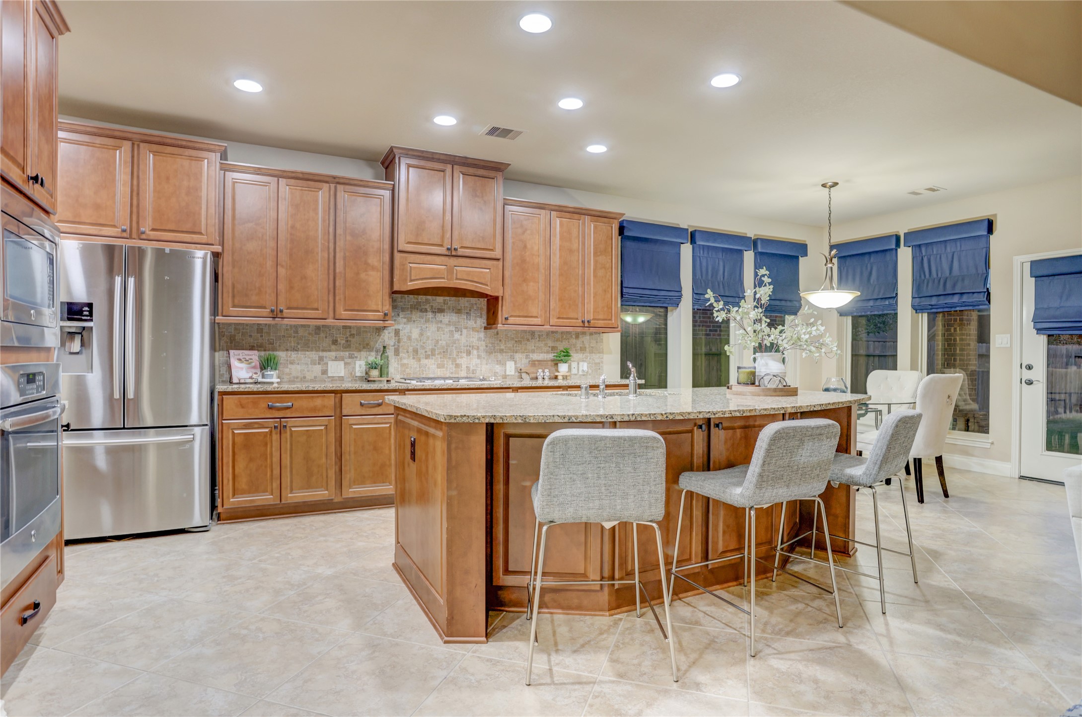 At the heart of the home, this beautifully appointed kitchen offers extensive cabinetry, stainless steel appliances, granite countertops, and a large center island that naturally brings family and friends together.