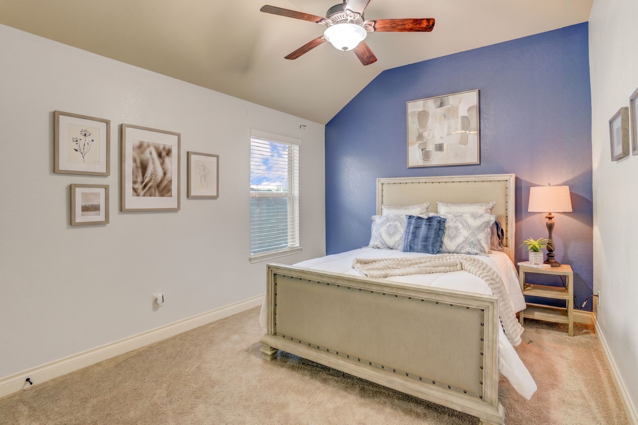 Bright and inviting, this upstairs bedroom features elevated ceilings and a functional layout designed to grow with your family's needs.