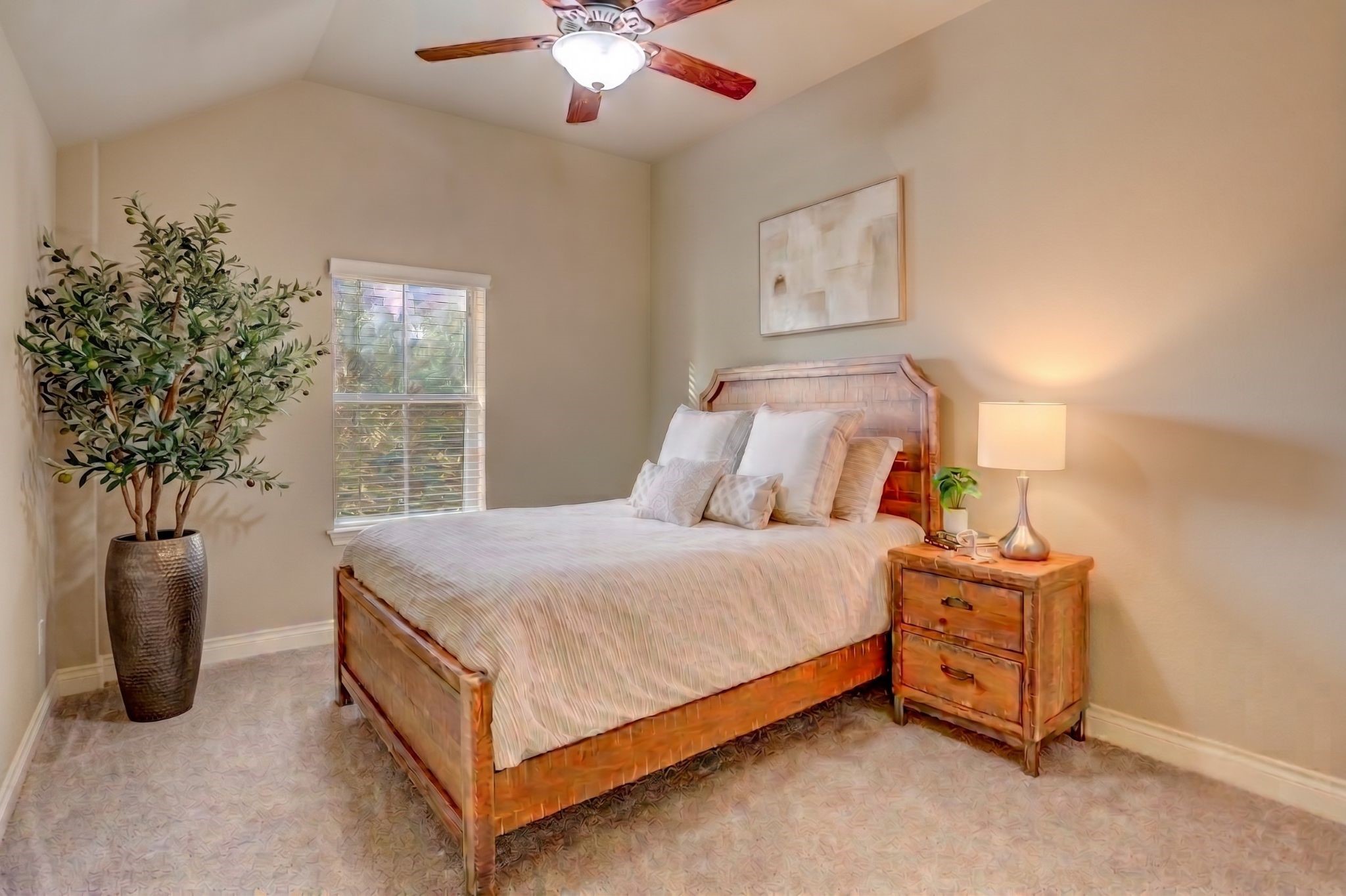 Spacious upstairs secondary bedroom featuring high ceilings, abundant natural light, and a versatile layout that easily accommodates family members, guests, or a home office.