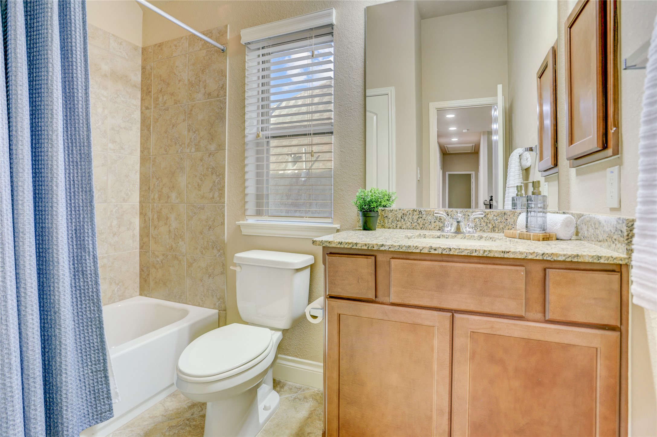 This upstairs full bathroom is thoughtfully positioned to serve the secondary bedrooms, offering added convenience for everyday living.