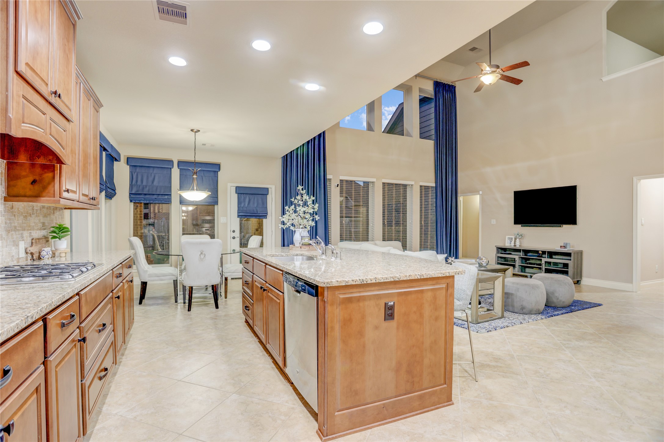 The open-concept design keeps everyone connected, with the kitchen overlooking the breakfast area and dramatic two-story family room. Whether you're preparing meals, helping with homework, or entertaining guests, this thoughtfully designed space is built for the way you live.