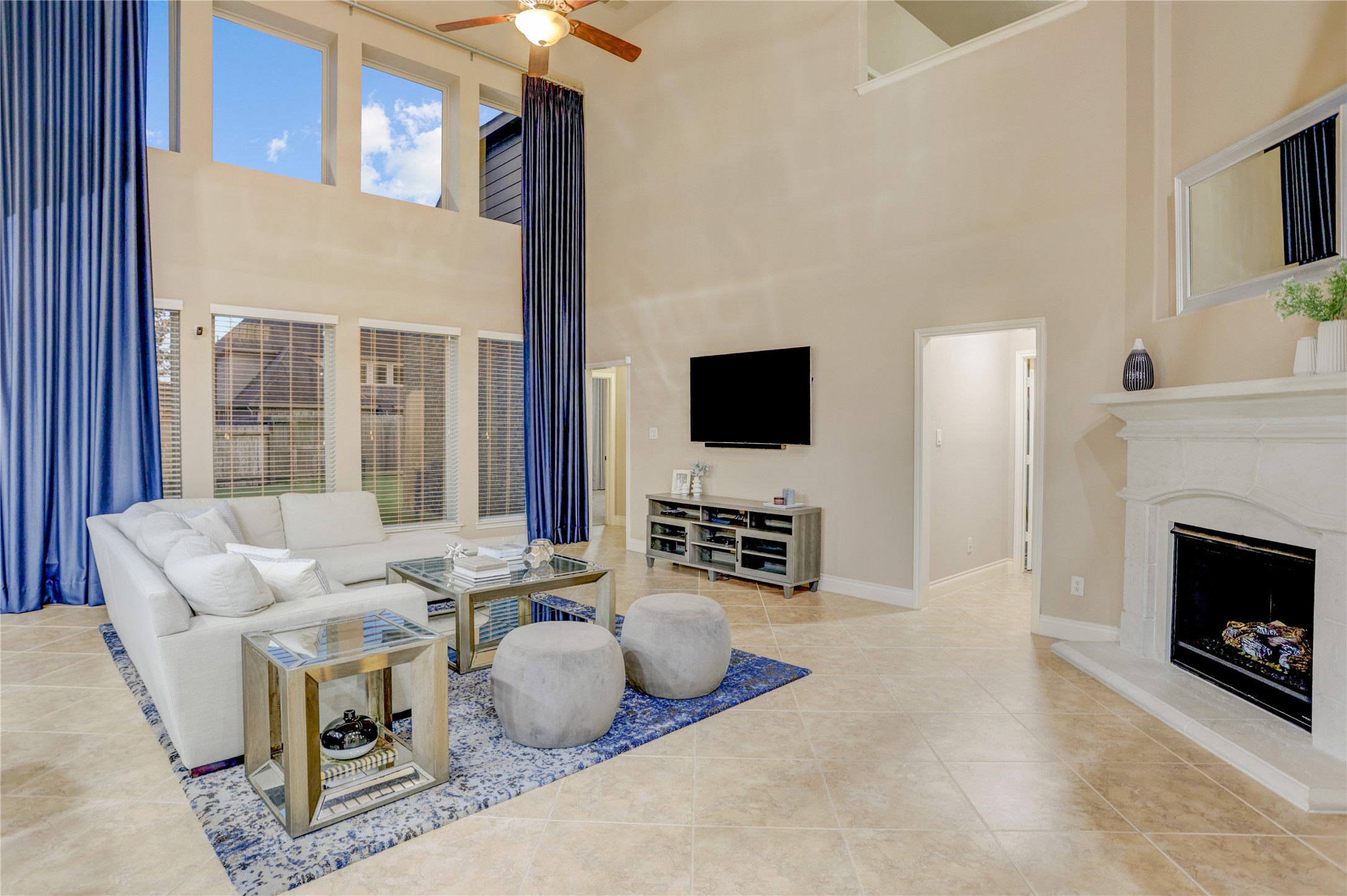 Whether you're hosting guests or enjoying a quiet evening at home, this spacious family room offers an inviting atmosphere with abundant natural light, a cozy gas fireplace, and views of the backyard.