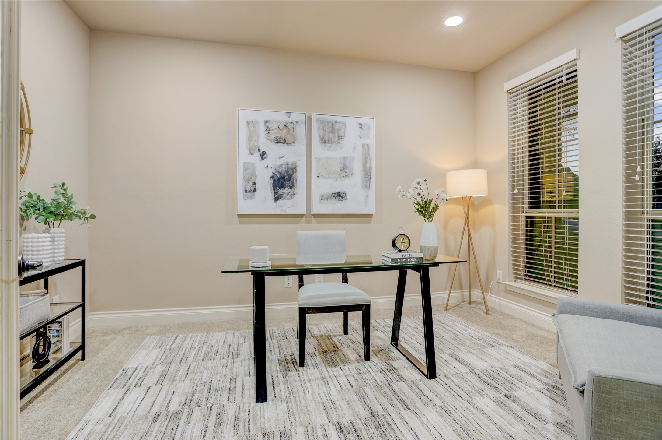 Dedicated home office with elegant French doors, plush carpeting, and large windows that fill the space with natural light. This private workspace offers the perfect setting for working from home, studying, or creating a quiet reading room.