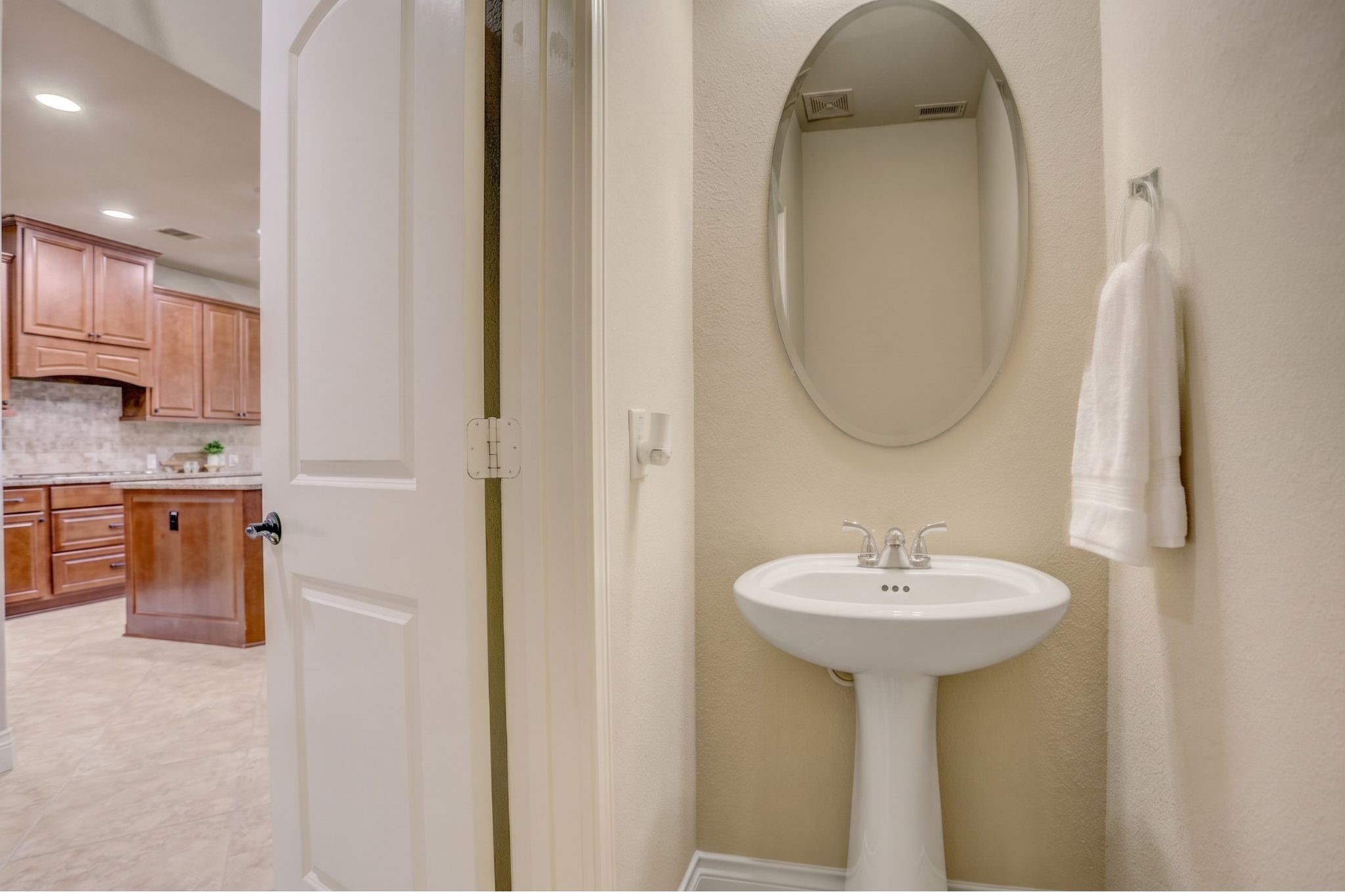 The main level powder bath is ideally situated for entertaining, allowing guests easy access without entering the home's private living spaces.