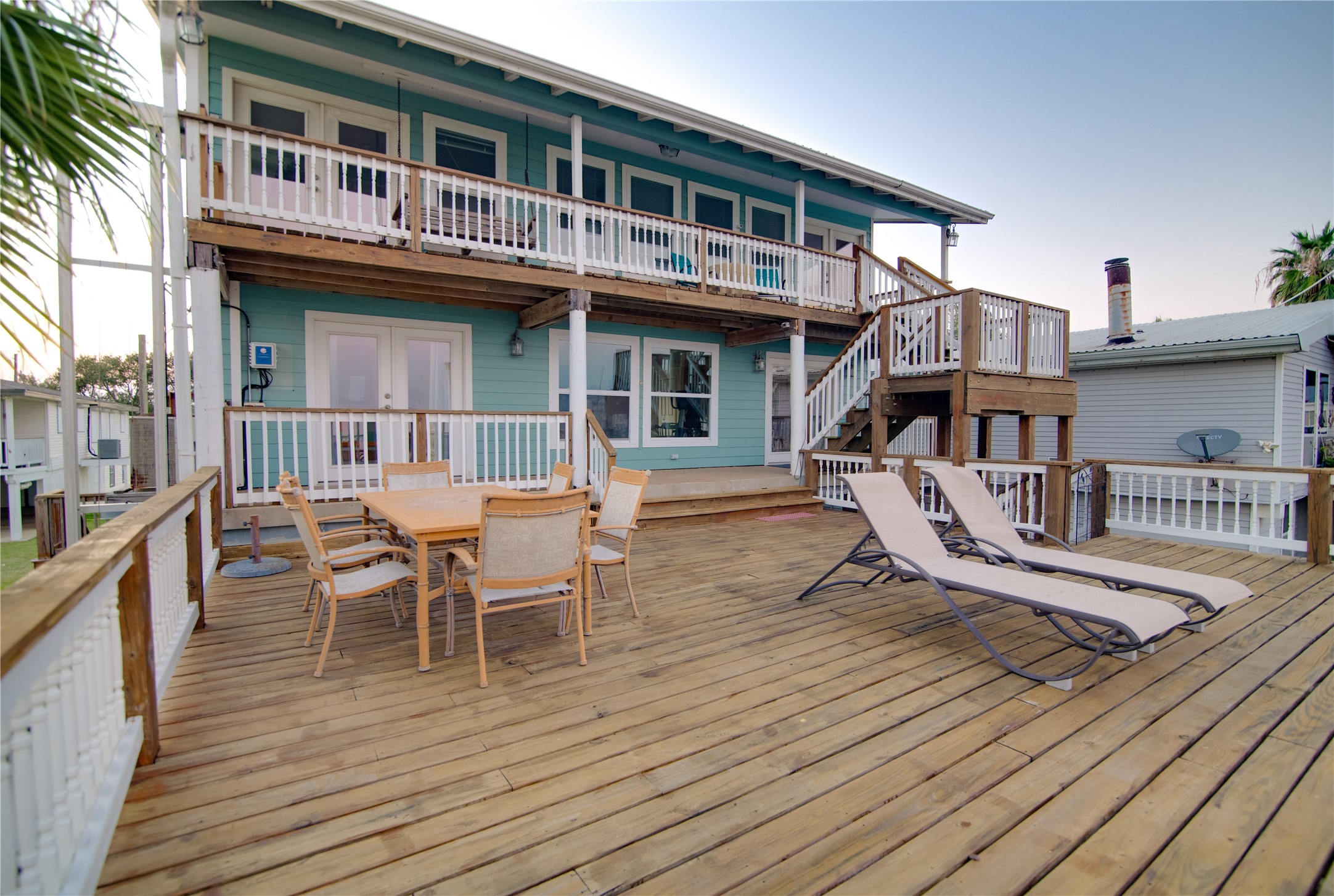 This expansive deck stretches out toward the water, offering uninterrupted views of the shimmering bay. Spacious enough for lounging, dining, and entertaining, it provides the perfect spot to soak in sunsets or enjoy the gentle coastal breeze. With room for both relaxation and social gatherings, the deck seamlessly extends the living space outdoors, making waterfront living truly effortless and enjoyable.