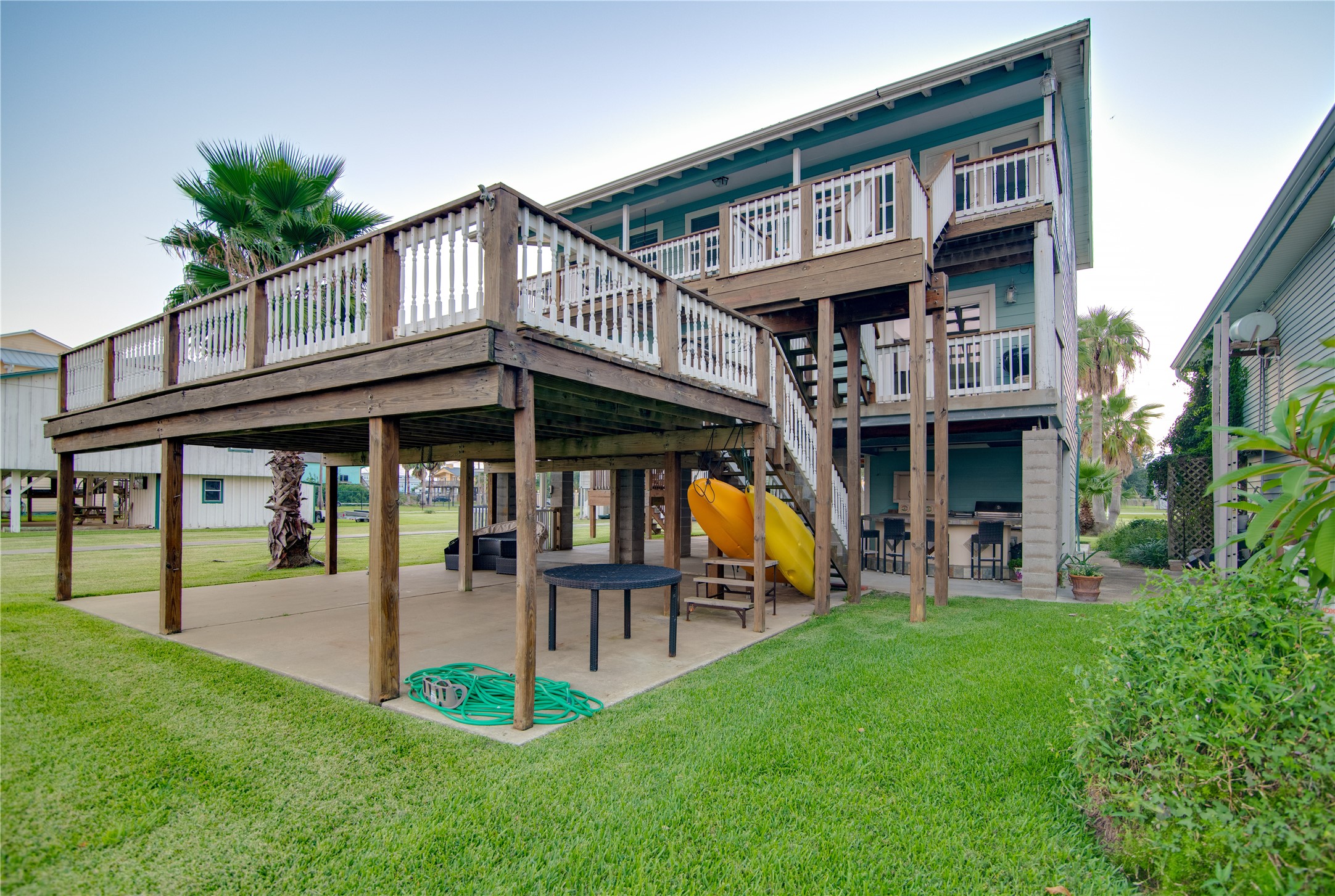 Beneath, the covered area provides a spacious, sheltered zone perfect for outdoor entertaining, parking, or simply enjoying the breeze.
