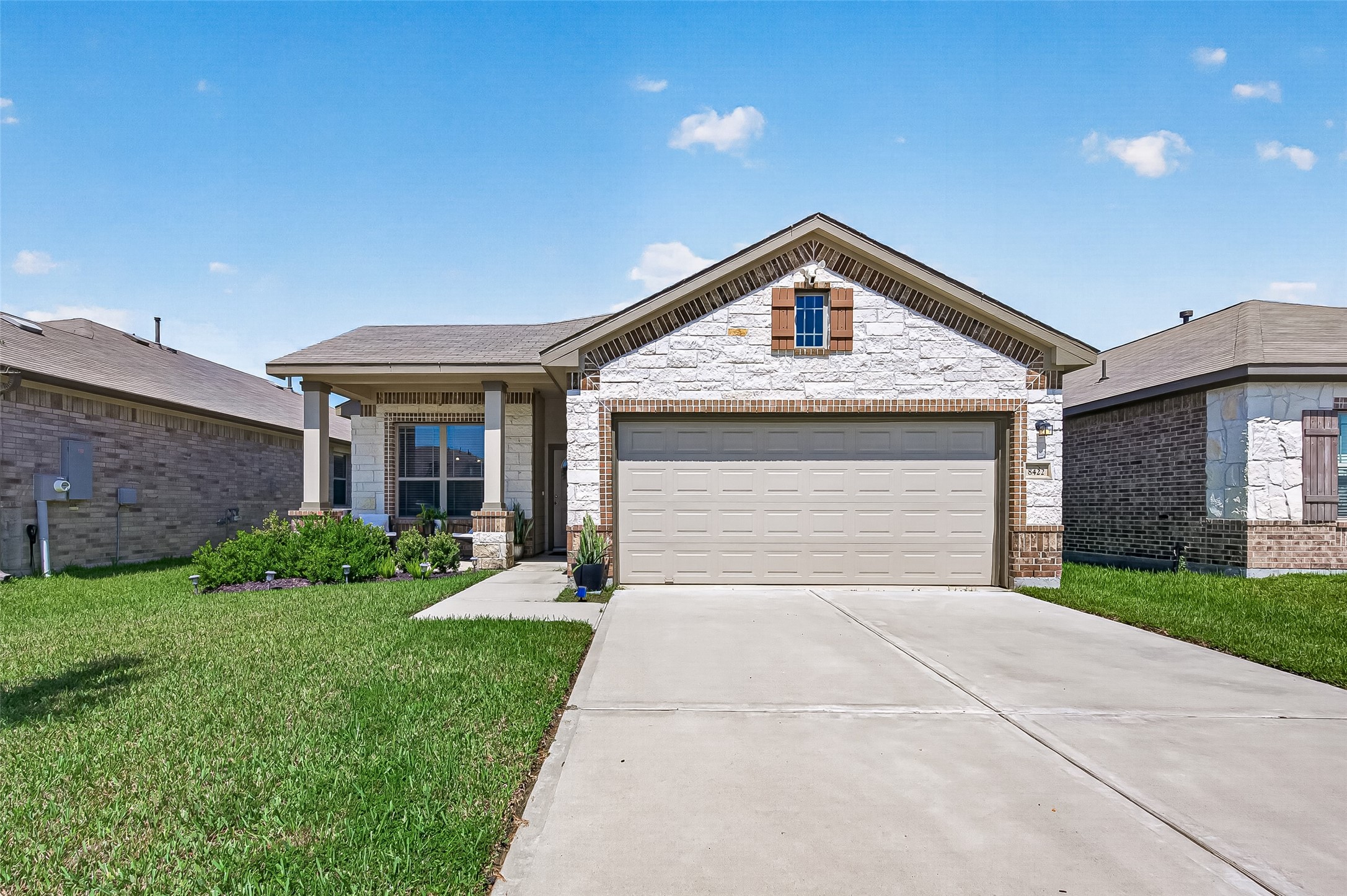 Charming single-story home with a modern stone facade, spacious driveway, and well-maintained front yard. Charming single-story home with a modern stone facade, spacious driveway, and well-maintained front yard.