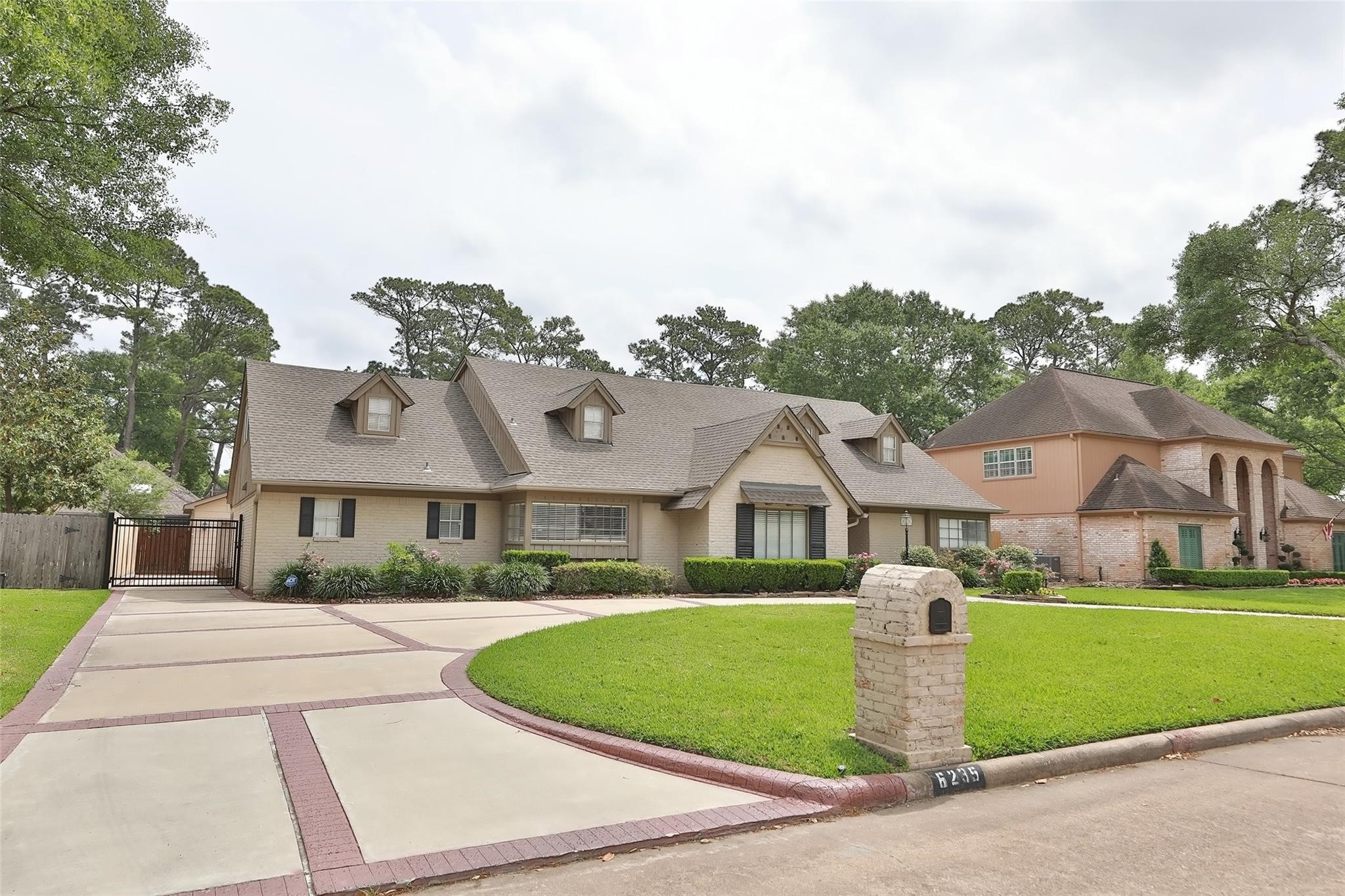 This charming two-story home features a spacious driveway, manicured lawn, and a welcoming exterior with multiple dormer windows. It's set in a lush, green neighborhood, offering both privacy and curb appeal. This charming two-story home features a spacious driveway, manicured lawn, and a welcoming exterior with multiple dormer windows. It's set in a lush, green neighborhood, offering both privacy and curb appeal.