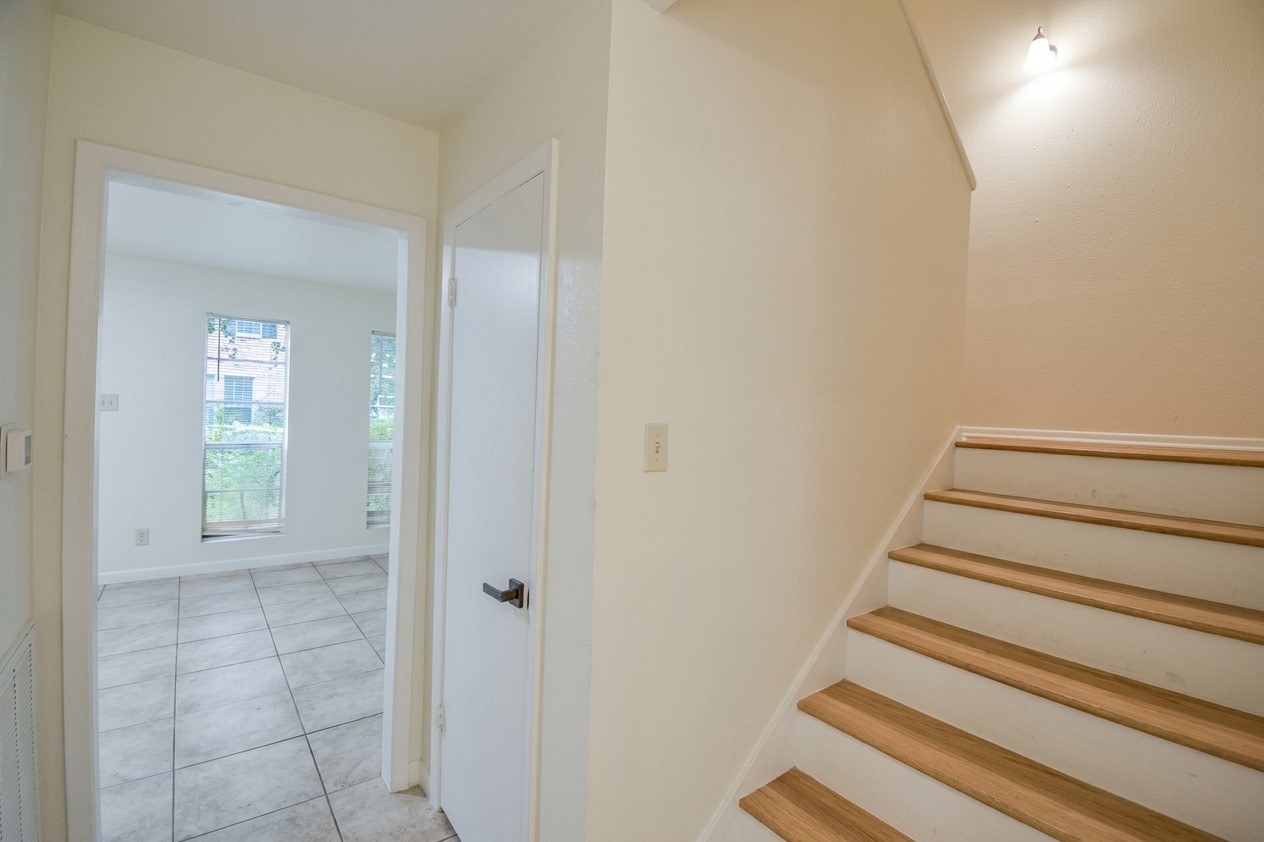 Stairs with view of living room