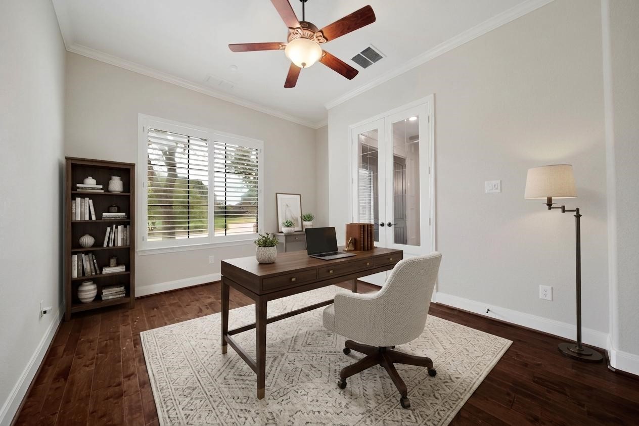 Just off the entry, the spacious study features glass-front French doors and plantation shutters, offering the perfect setting for working from home. (Virtually Staged)