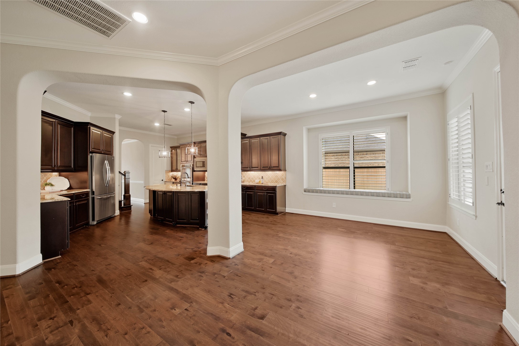 The light and bright breakfast area features a charming window with built-in bench seating, creating the perfect spot for casual meals and morning coffee.