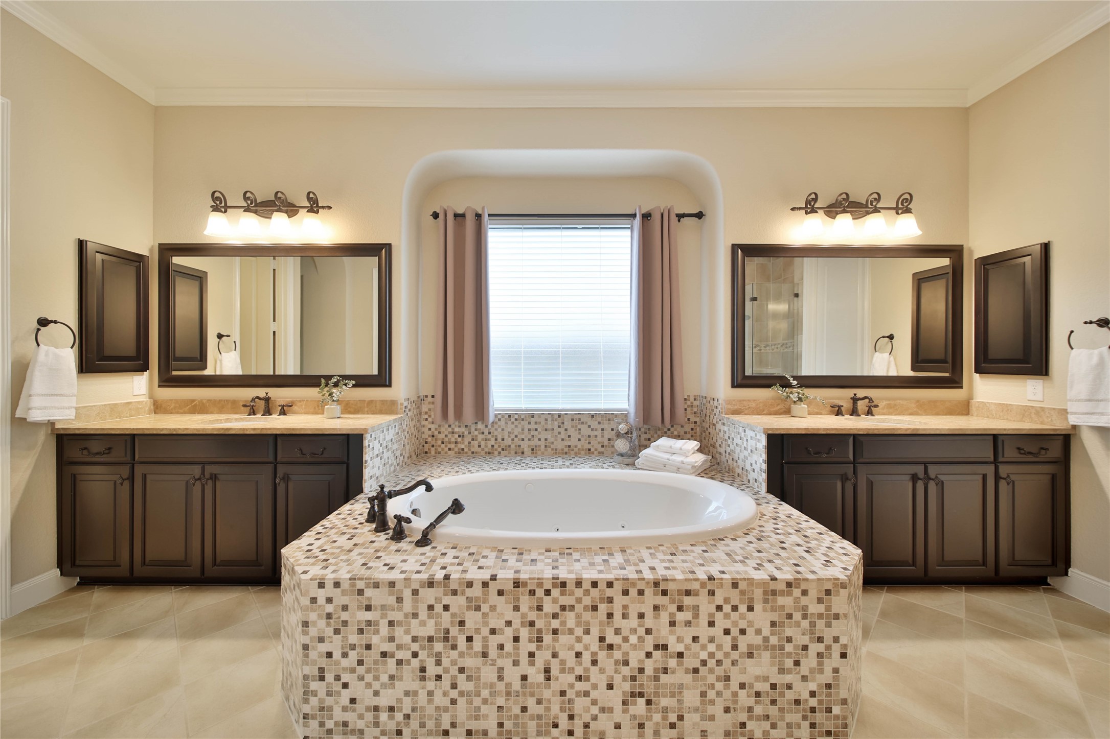 The primary bath provides the perfect place to unwind, featuring dual vanities, a soothing jetted tub, and a separate shower for a truly elevated experience.