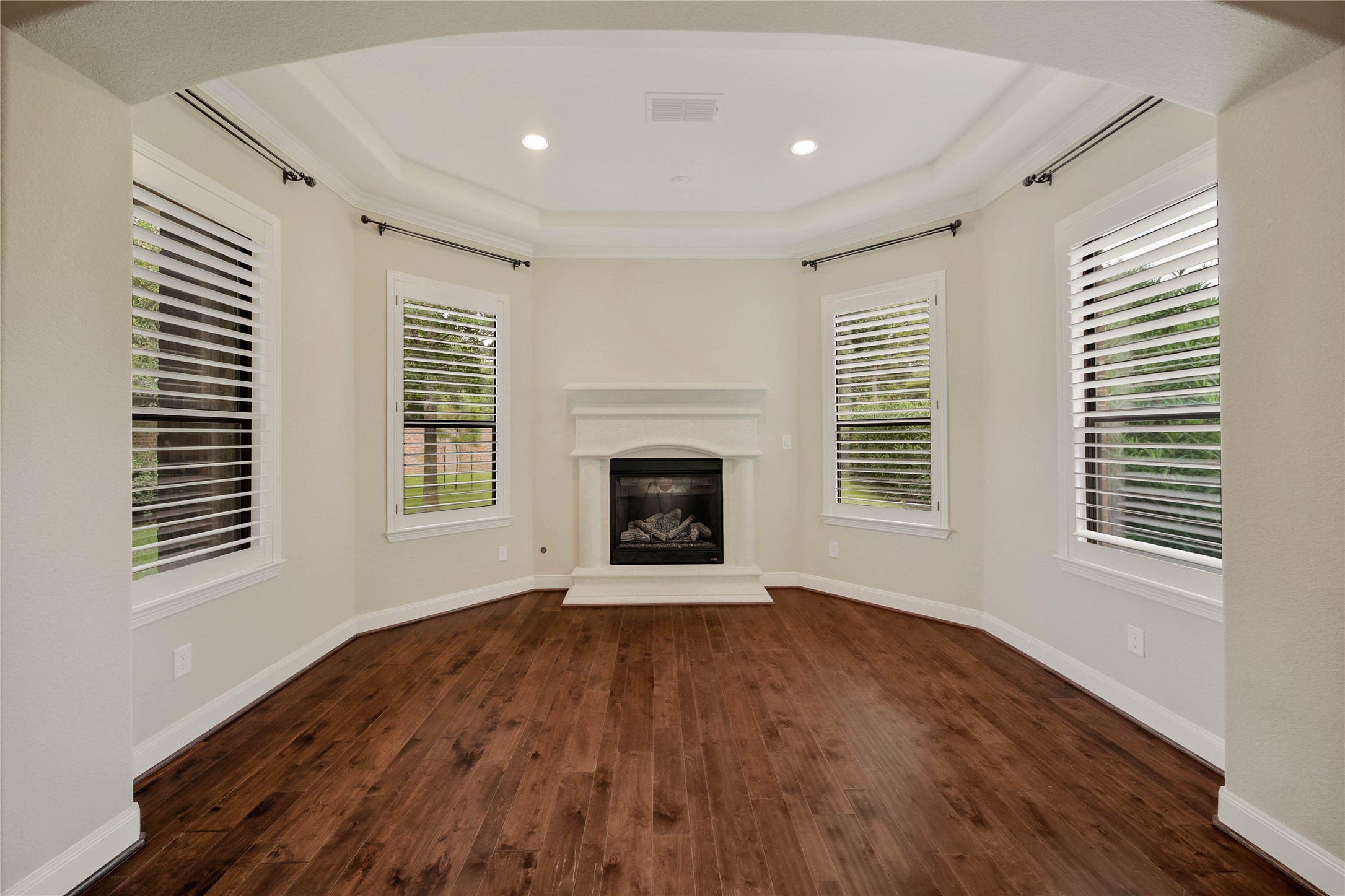 A true owners sanctuary, the primary suite includes a private sitting area with a gas log fireplace.