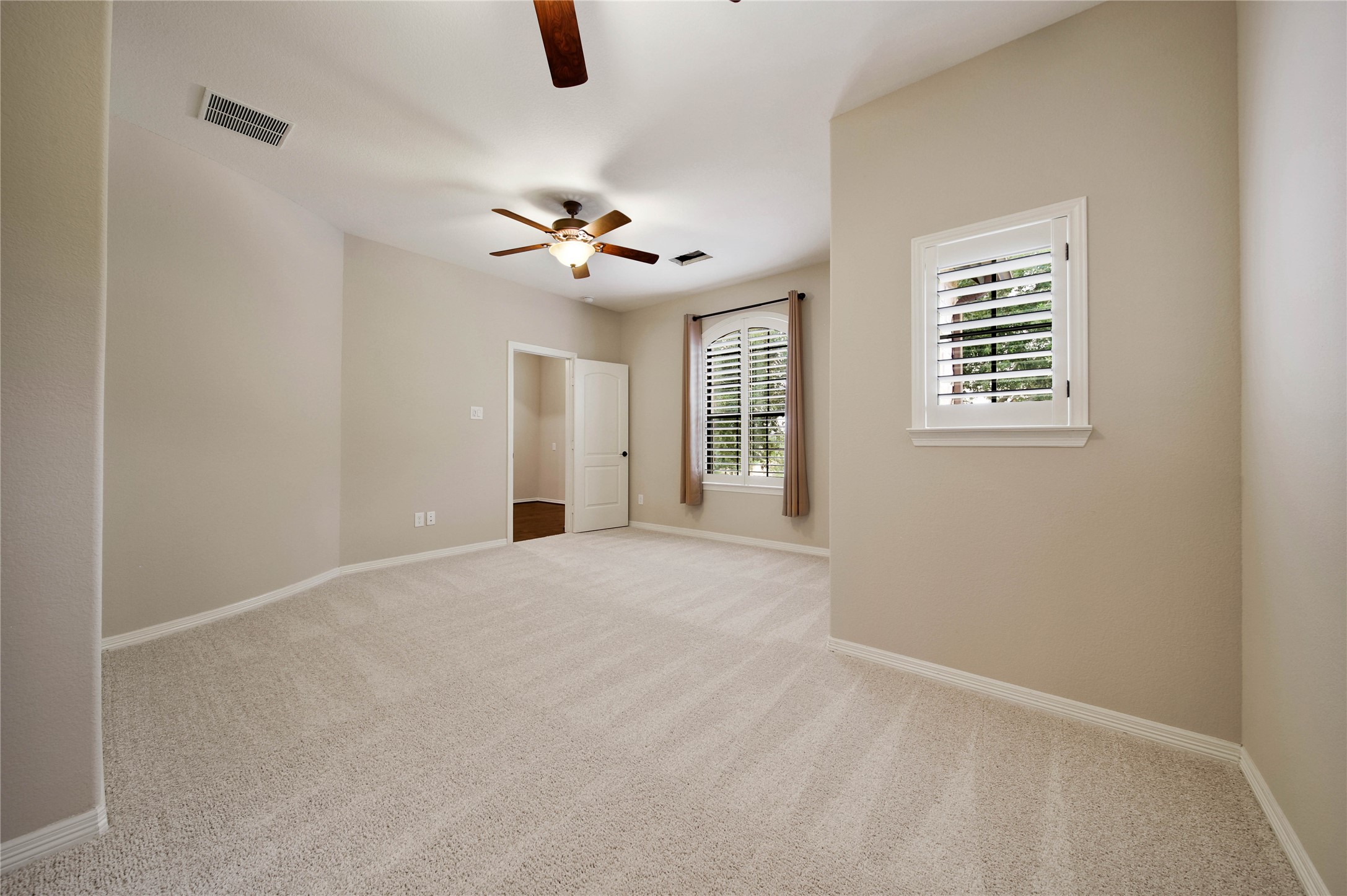 Every secondary bedroom is designed with comfort in mind, featuring shutters, spacious walk-in closets, and ceiling fans (this one has two!)