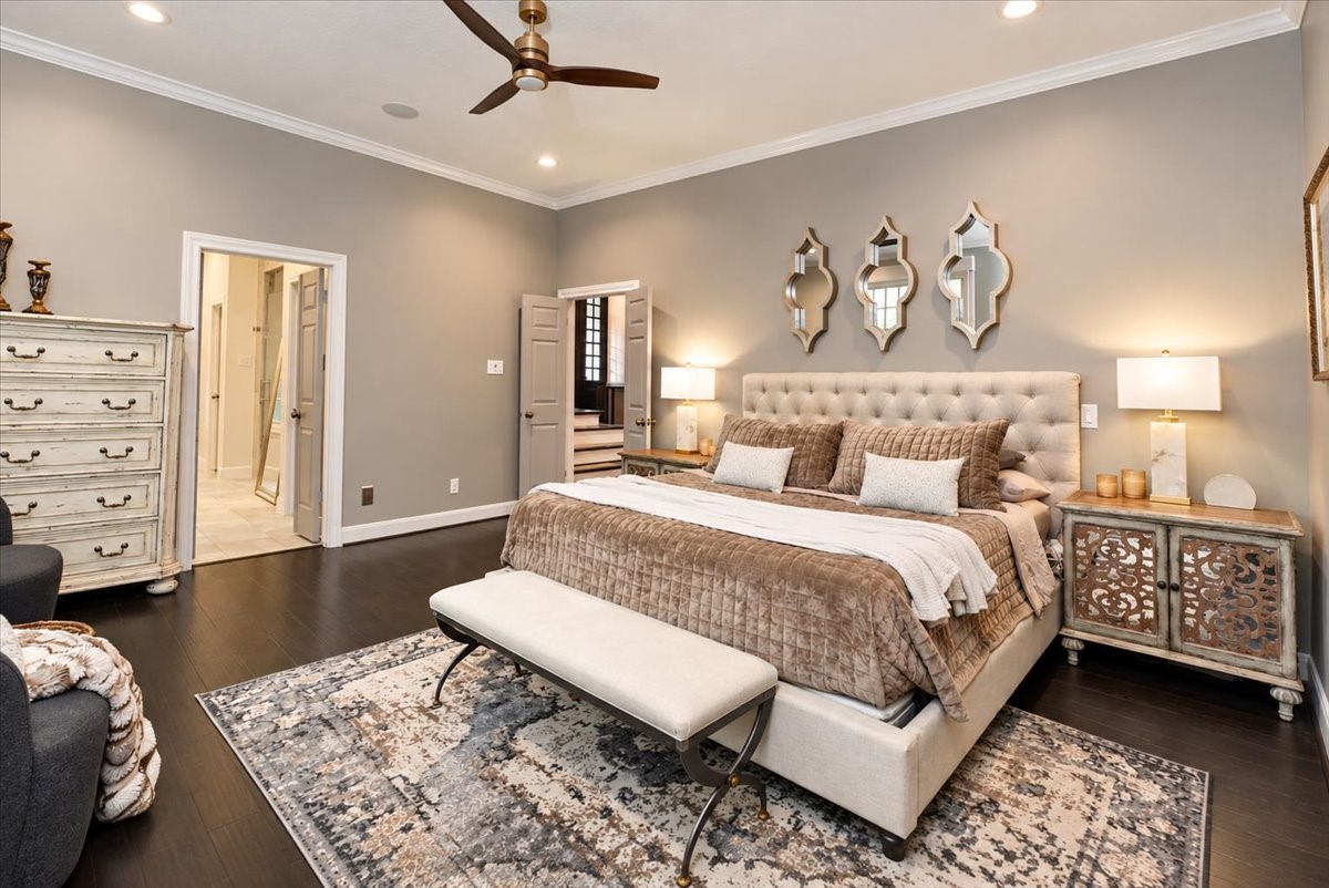 An elegant place to start and end each day. Dark hardwood floors, soft neutral walls, and a main-level location make this primary suite as practical as it is beautiful, with the bedroom already wired for your TV.