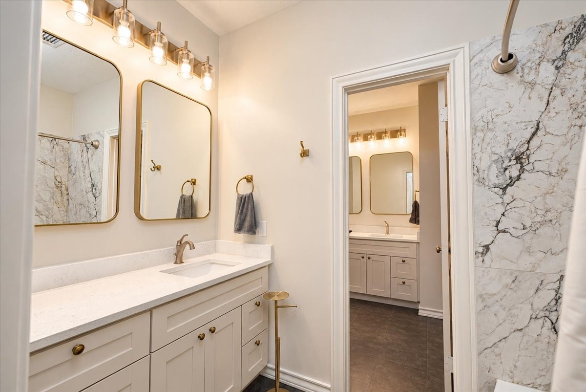 Shared between two secondary bedrooms, this fully remodeled 2024 bath features a new tub/shower with upgraded tile, and a clean, modern finish that makes everyday routines easy.