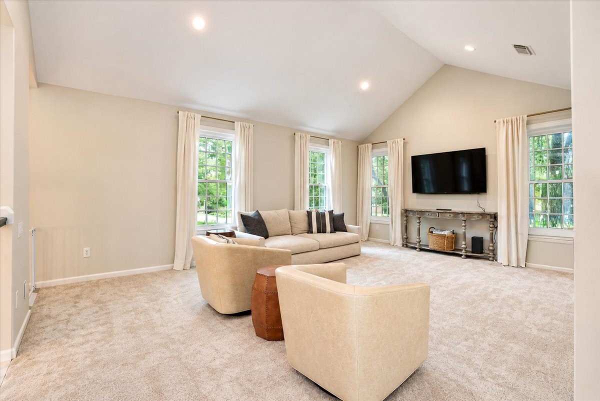 Room to play, gather, and unwind! This huge upstairs game room has a vaulted ceiling, recessed lighting, and new carpet with a quality pad (2022), so its comfortable for movie nights and weekend hangouts.