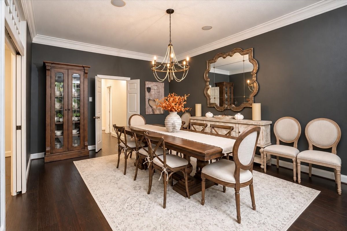 Holiday dinners, birthdays, and Sunday suppers all feel special here! This elegant formal dining room is wrapped in crown molding and dark hardwood floors, with a statement chandelier overhead and room for a table that seats the whole family.