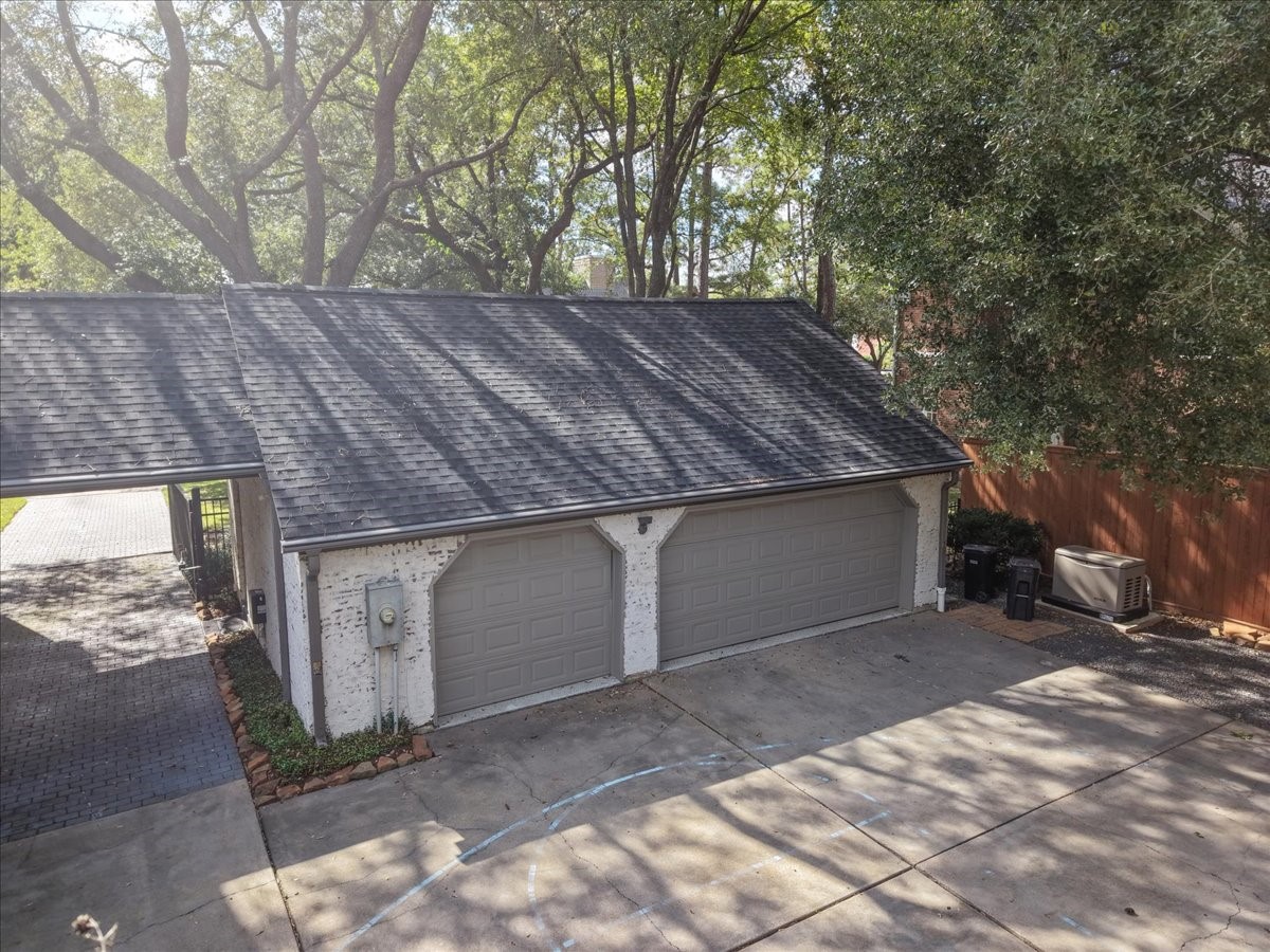 Inside, this garage has custom cabinets for storage and durable epoxy floors (2023), and the paver drive and porte cochere make coming and going easy and covered.