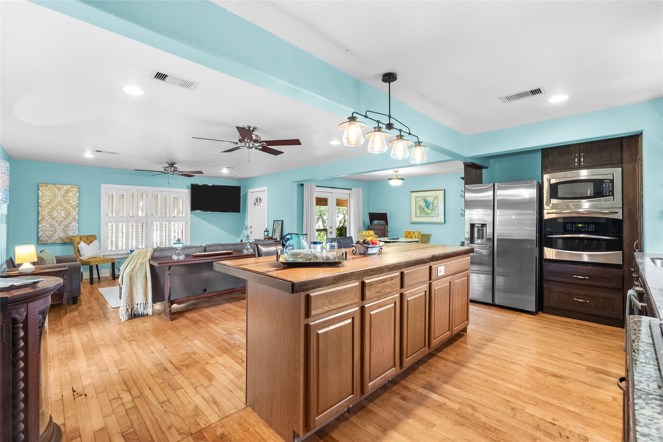Open kitchen overlooks the spacious living area and features a large center island with extensive workspace and storage