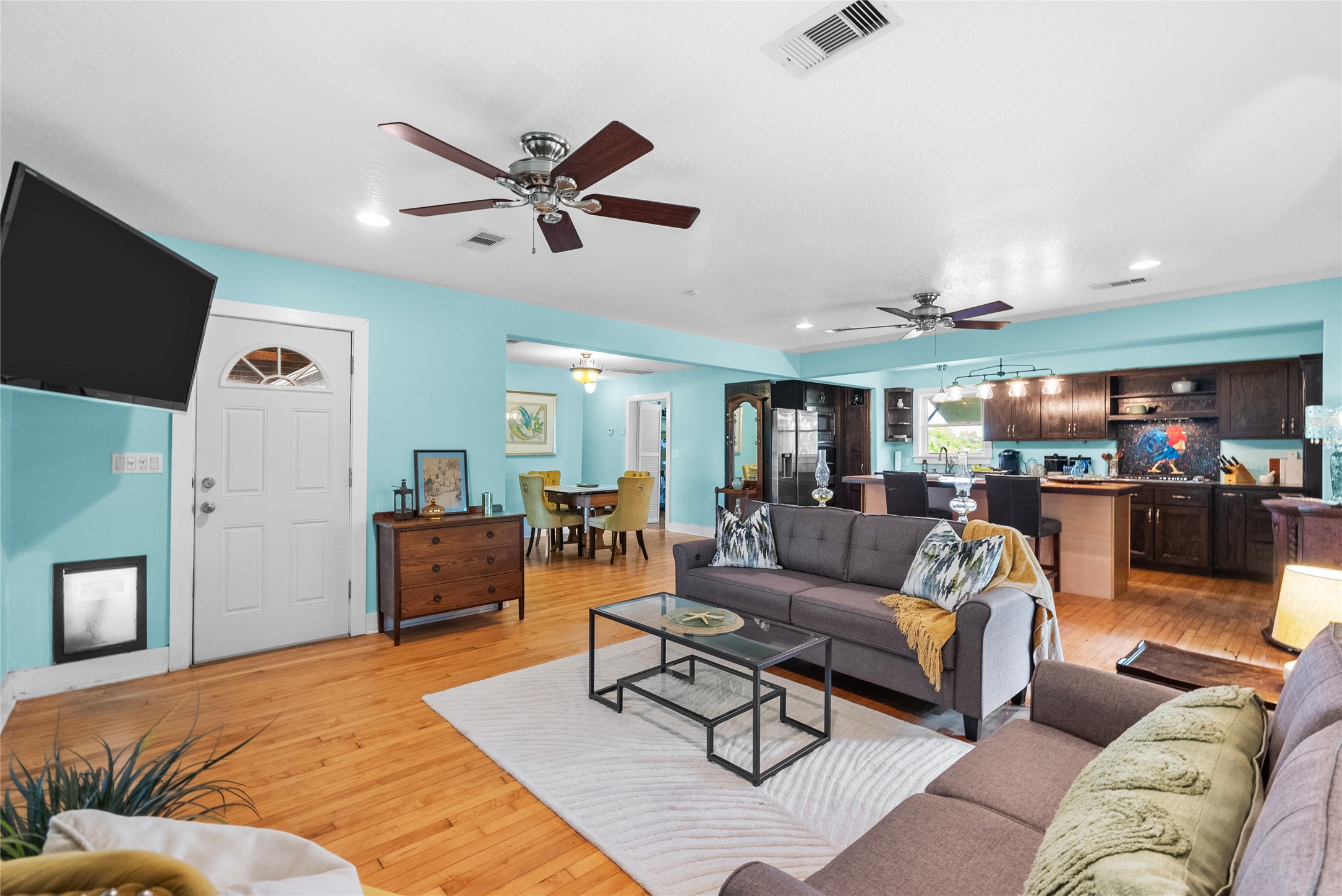 Open-concept living area connects seamlessly with the kitchen and dining spaces creating a comfortable layout for everyday living and entertaining