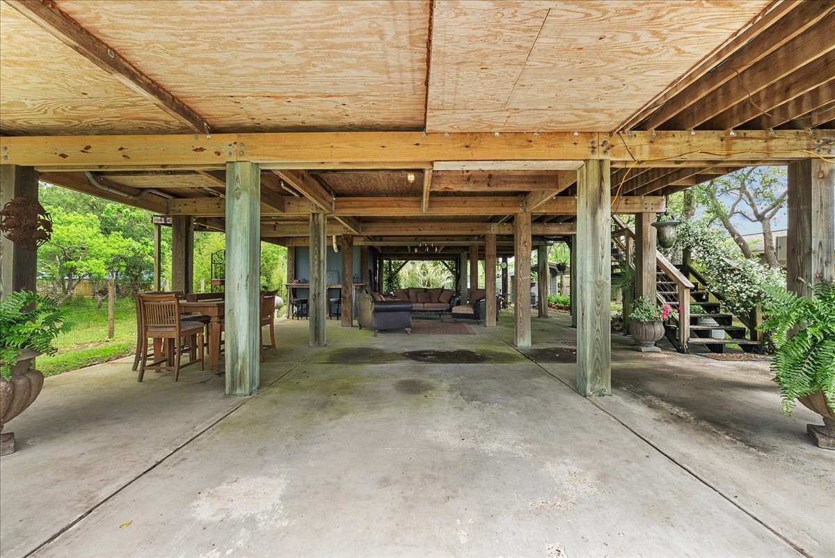 Substantial covered space beneath the home with a concrete surface and plenty of flexibility for parking, entertaining or additional outdoor use