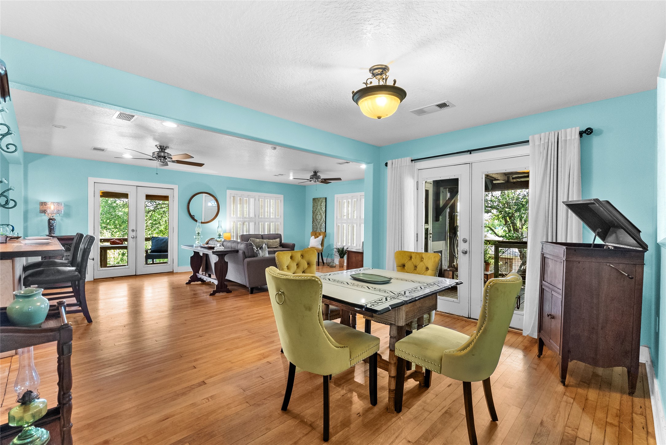 Dining area positioned just off the kitchen and living room with hardwood flooring and French doors opening to the exterior