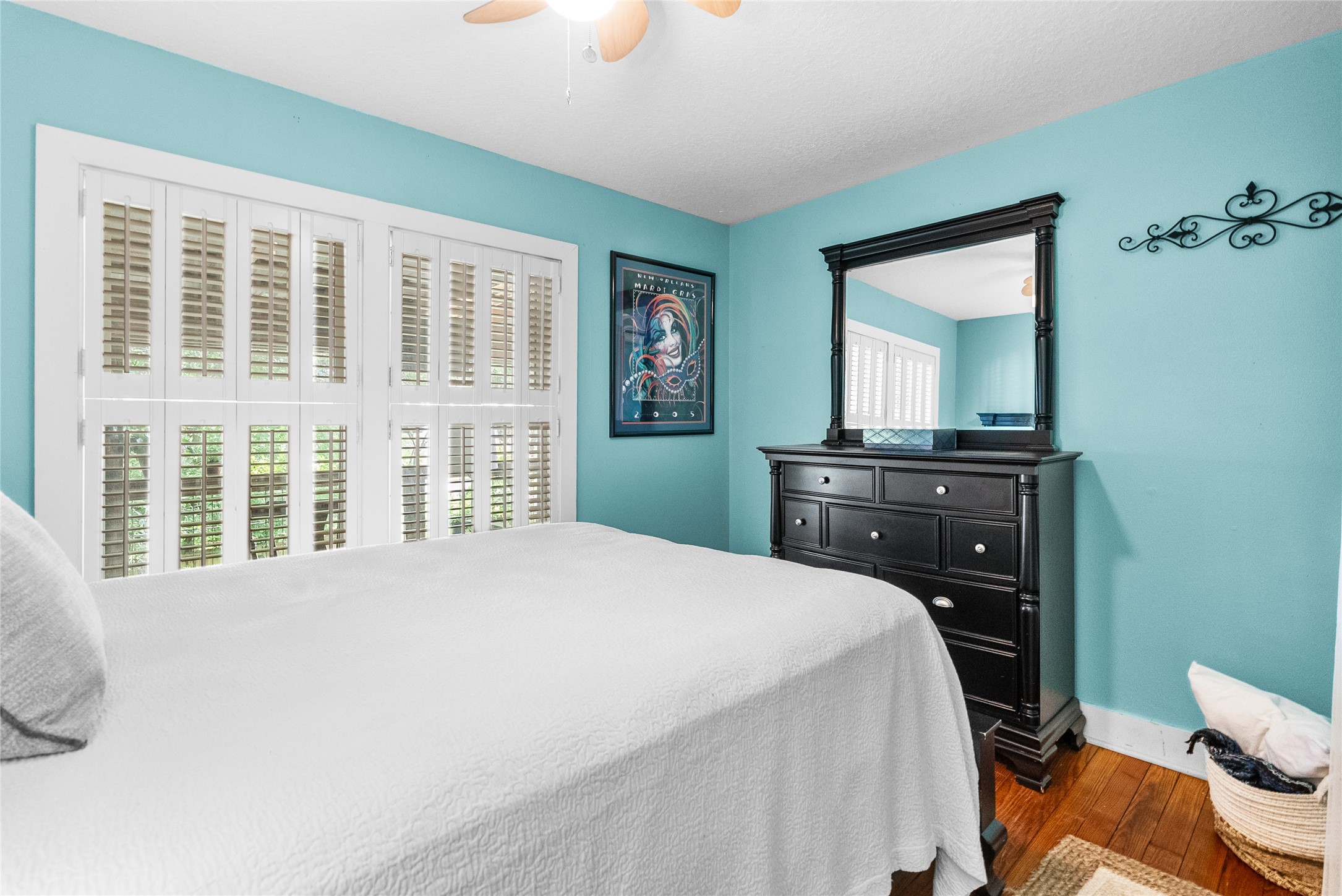 Secondary bedroom with hardwood flooring, plantation shutters and generous natural light