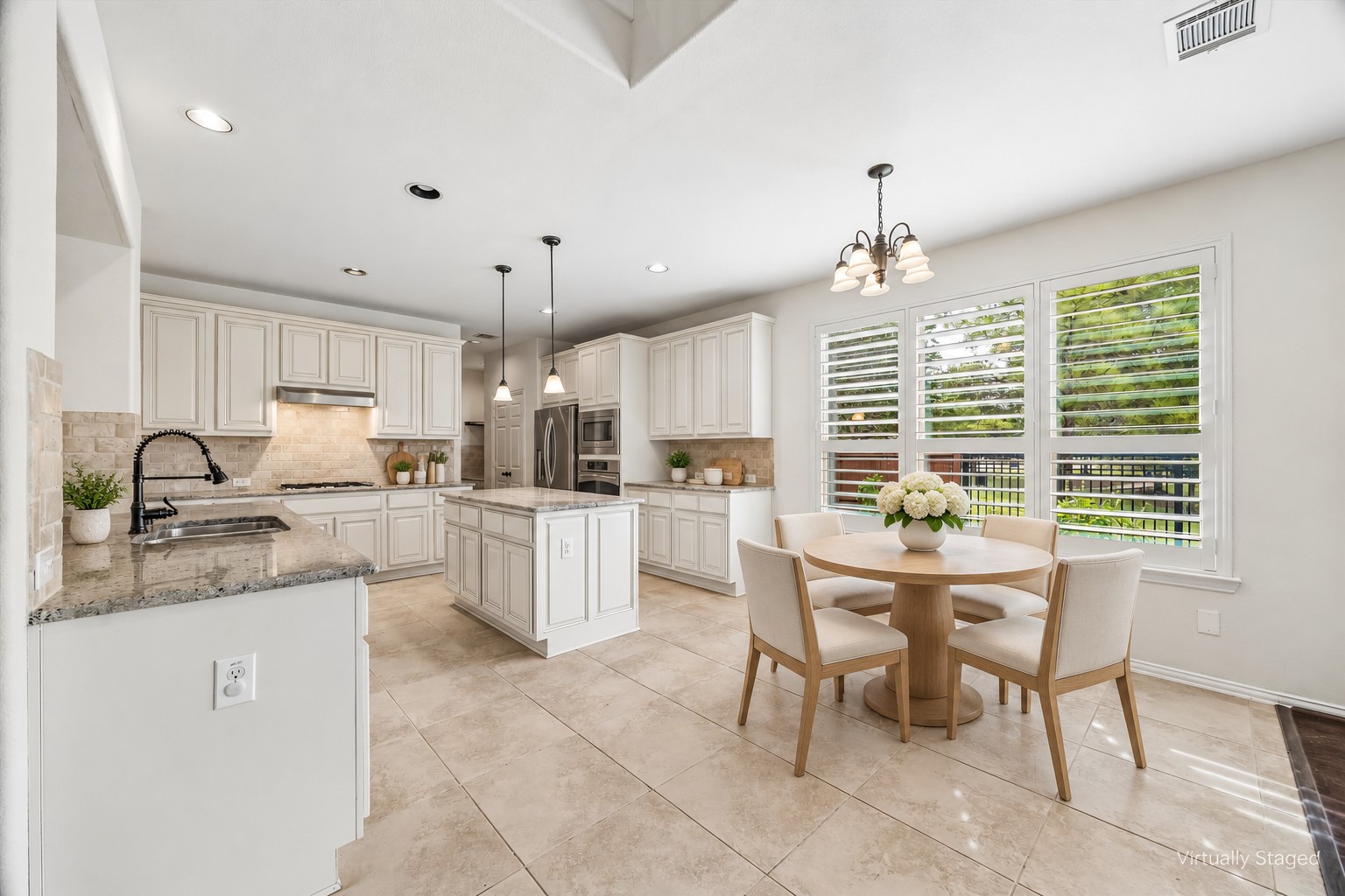 Virtually staged breakfast area to illustrate the breakfast area's dining potential, with lovely views through plantation shutters and open connection to the kitchen.