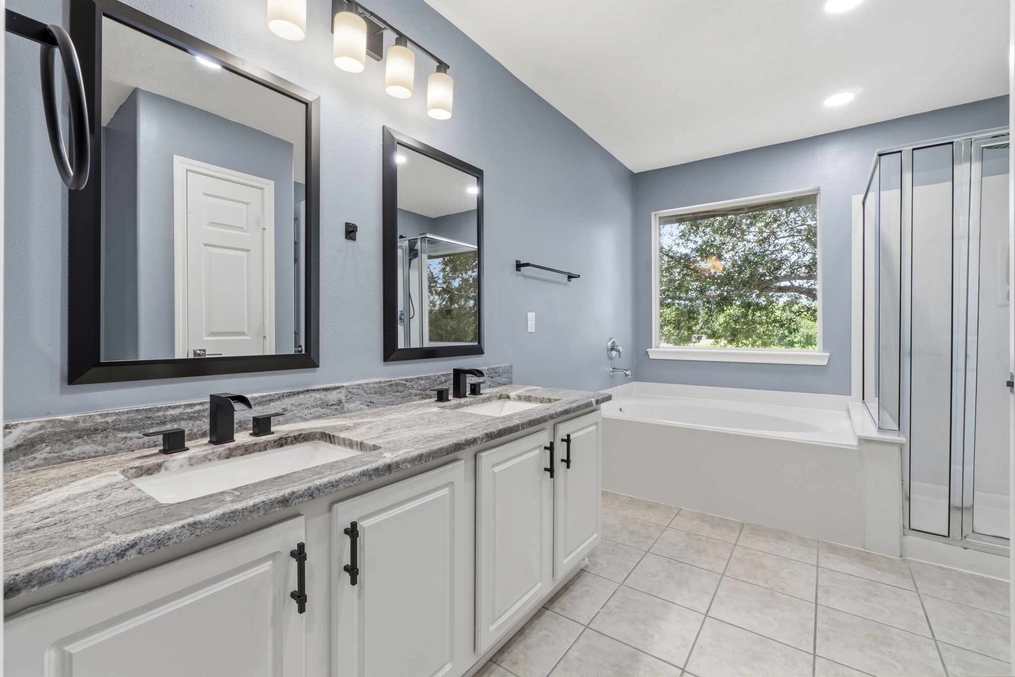 Freshly painted cabinets, modern faucets and light fixtures