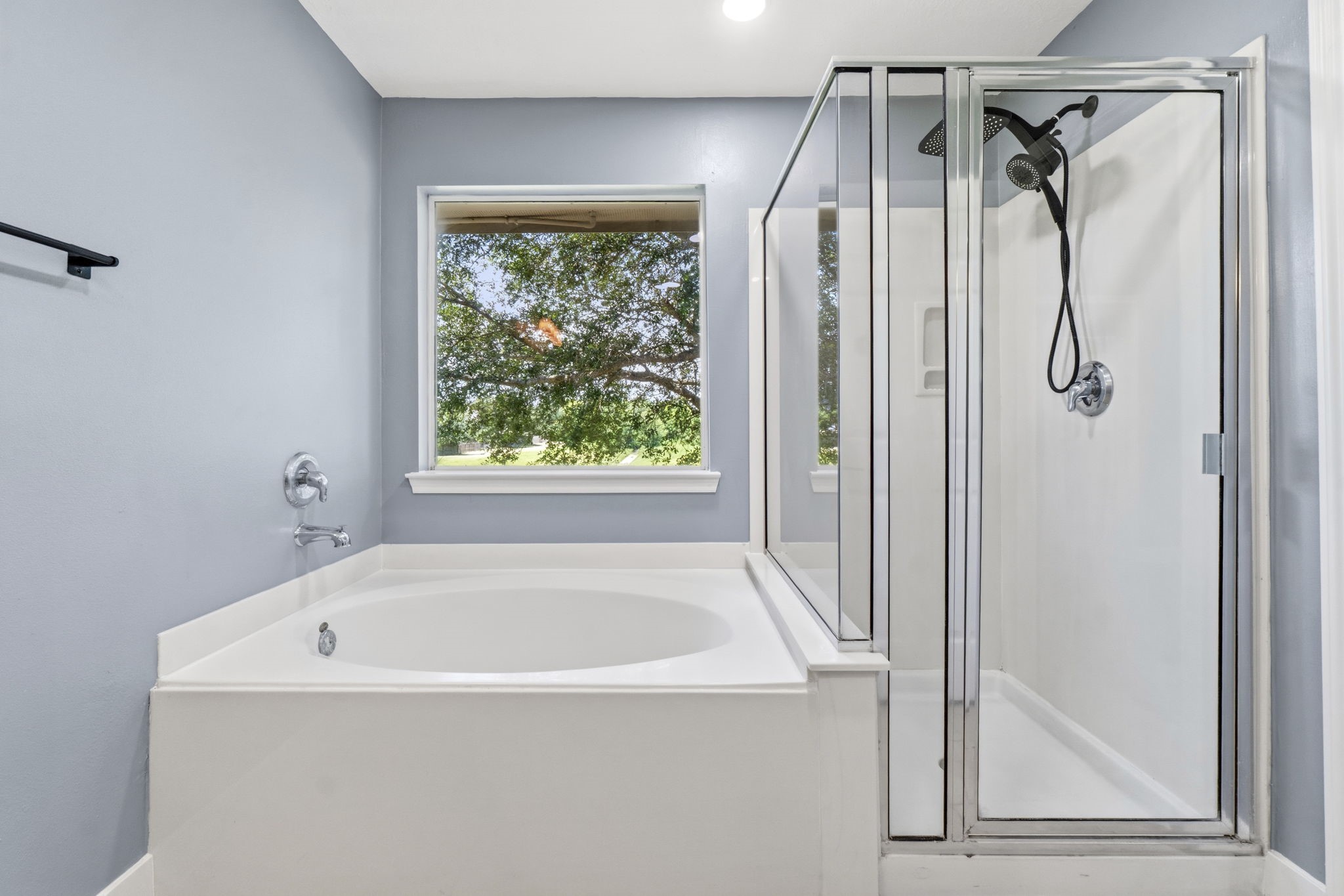 Oversized shower head and garden tub window