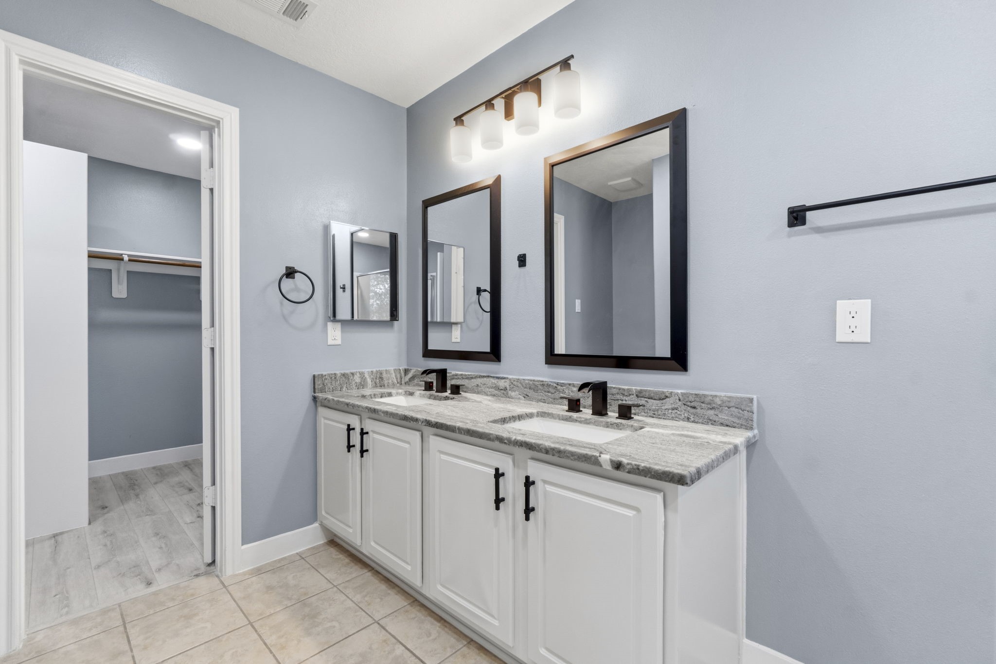 Granite countertops, designer mirrors, sleek cabinet handles