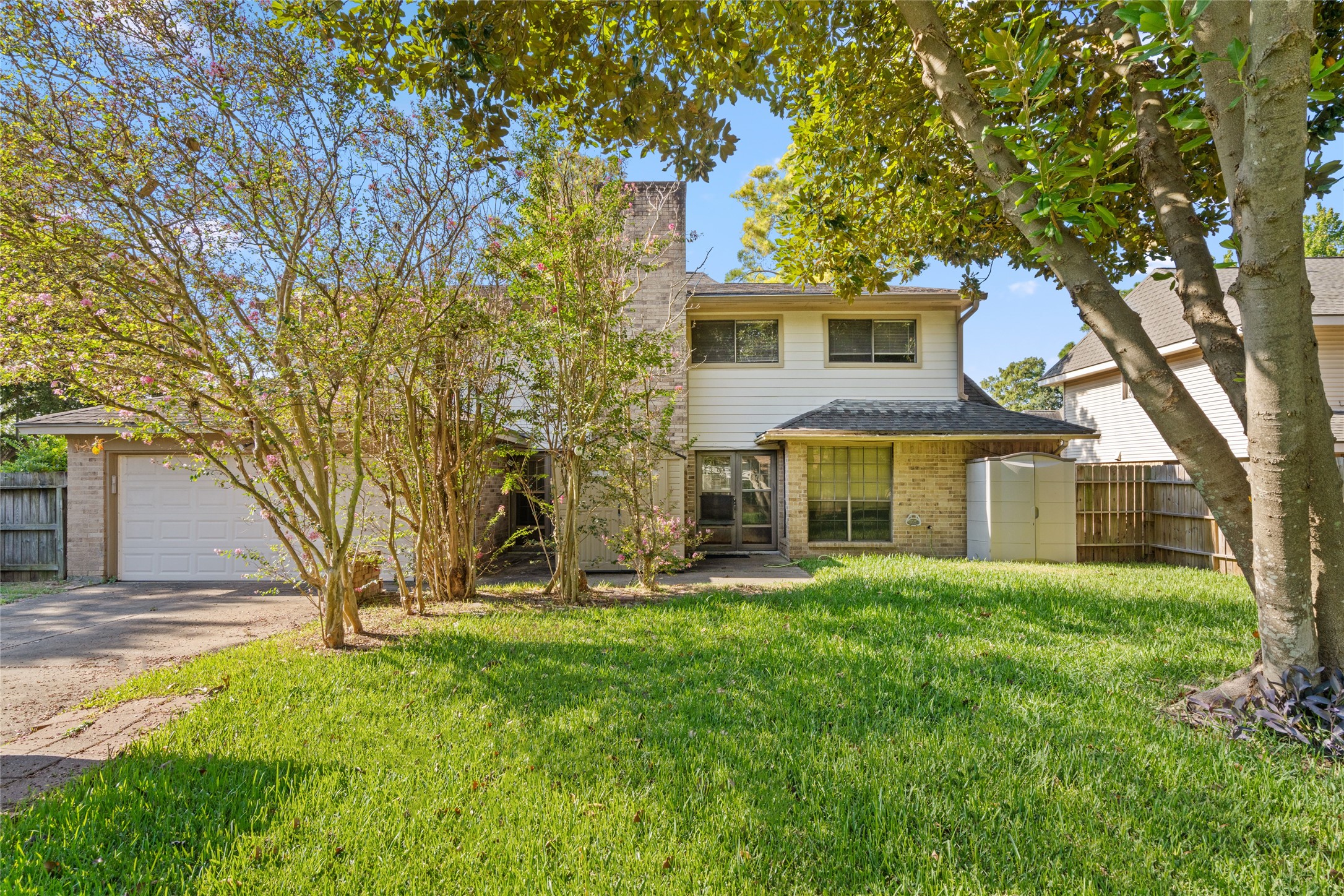 The home's two-story profile, spacious front lawn, mature trees, and welcoming driveway come together to create the established neighborhood presence buyers hope to find.