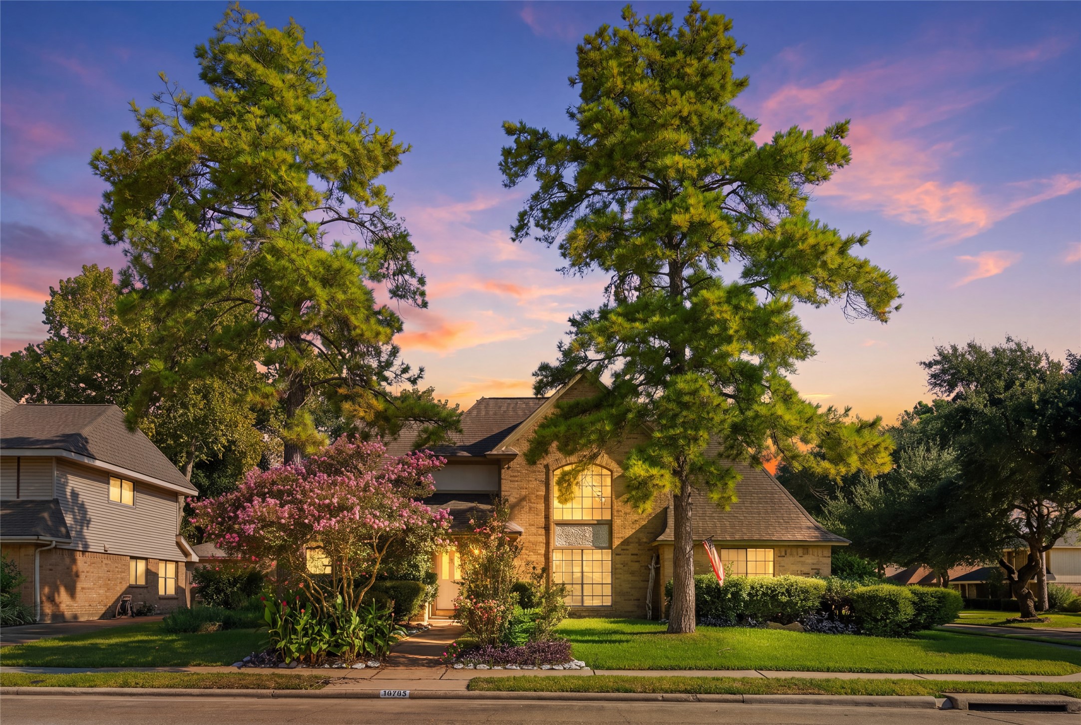 A charming brick residence framed by mature trees and beautifully landscaped gardens creates an inviting first impression, giving buyers the feeling of coming home to a peaceful, established neighborhood.