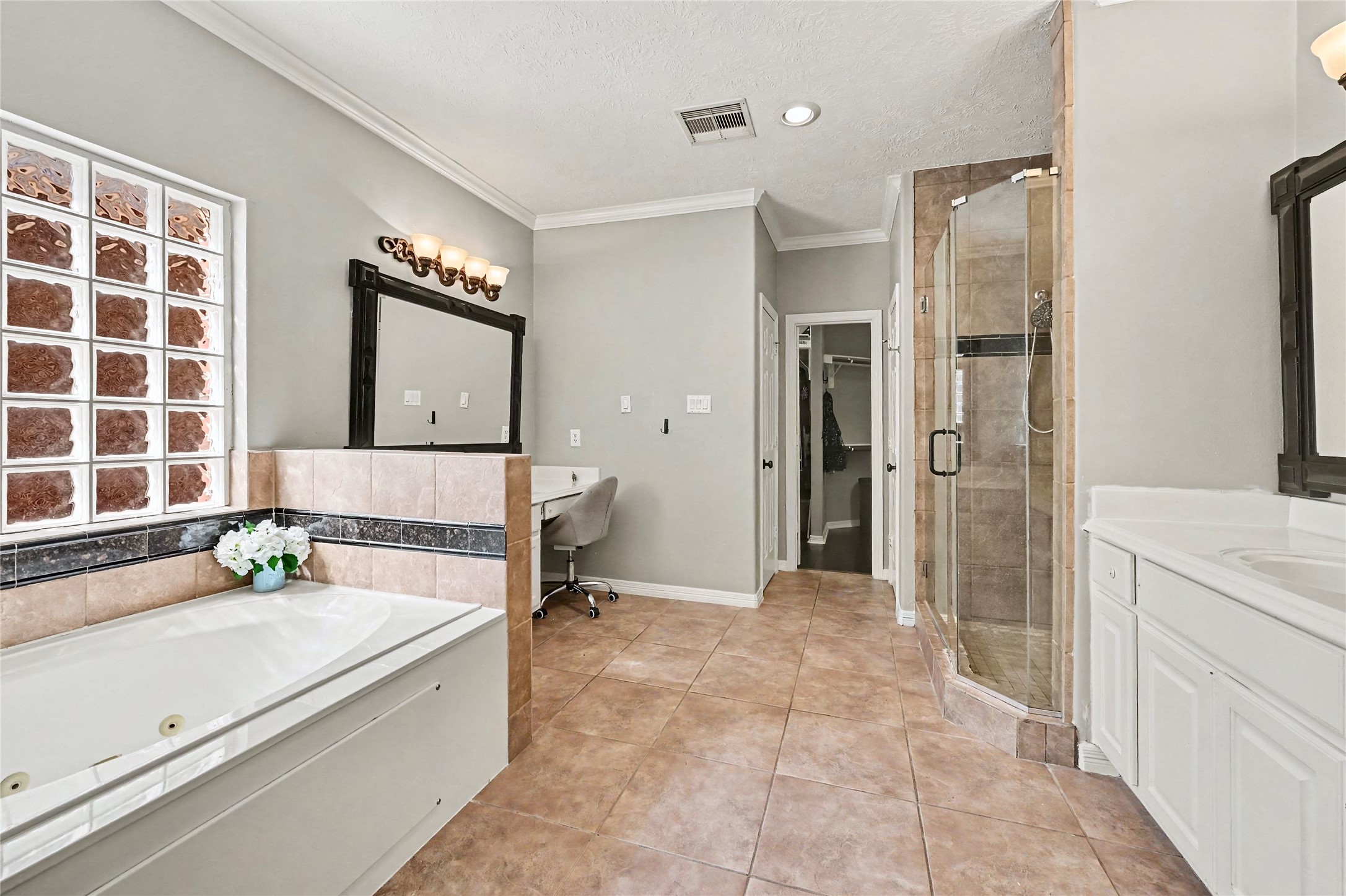 Primary bath with a spacious vanity, large mirror, and clean neutral finishes.