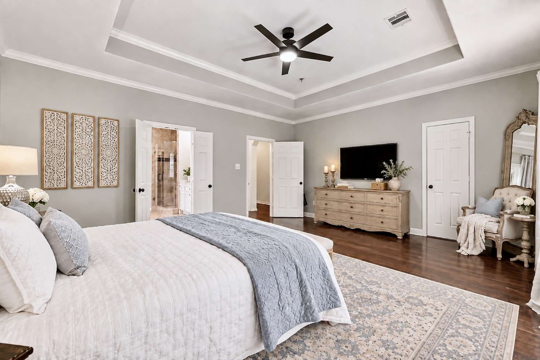 The spacious owners suite feels open and airy, featuring an expansive bath and an abundance of closet space.