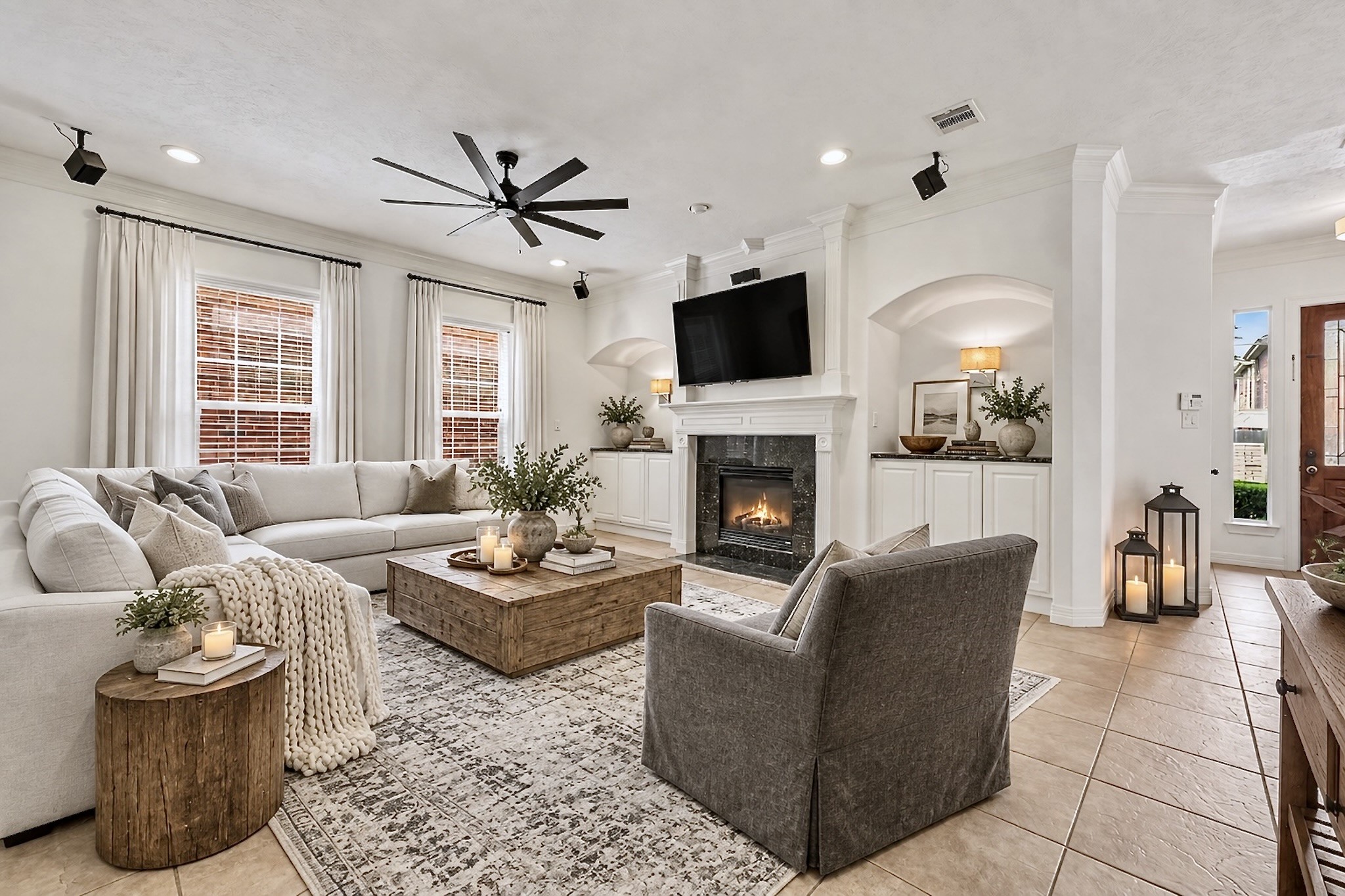 Inviting living room with fireplace, built-in cabinetry, and abundant natural light.