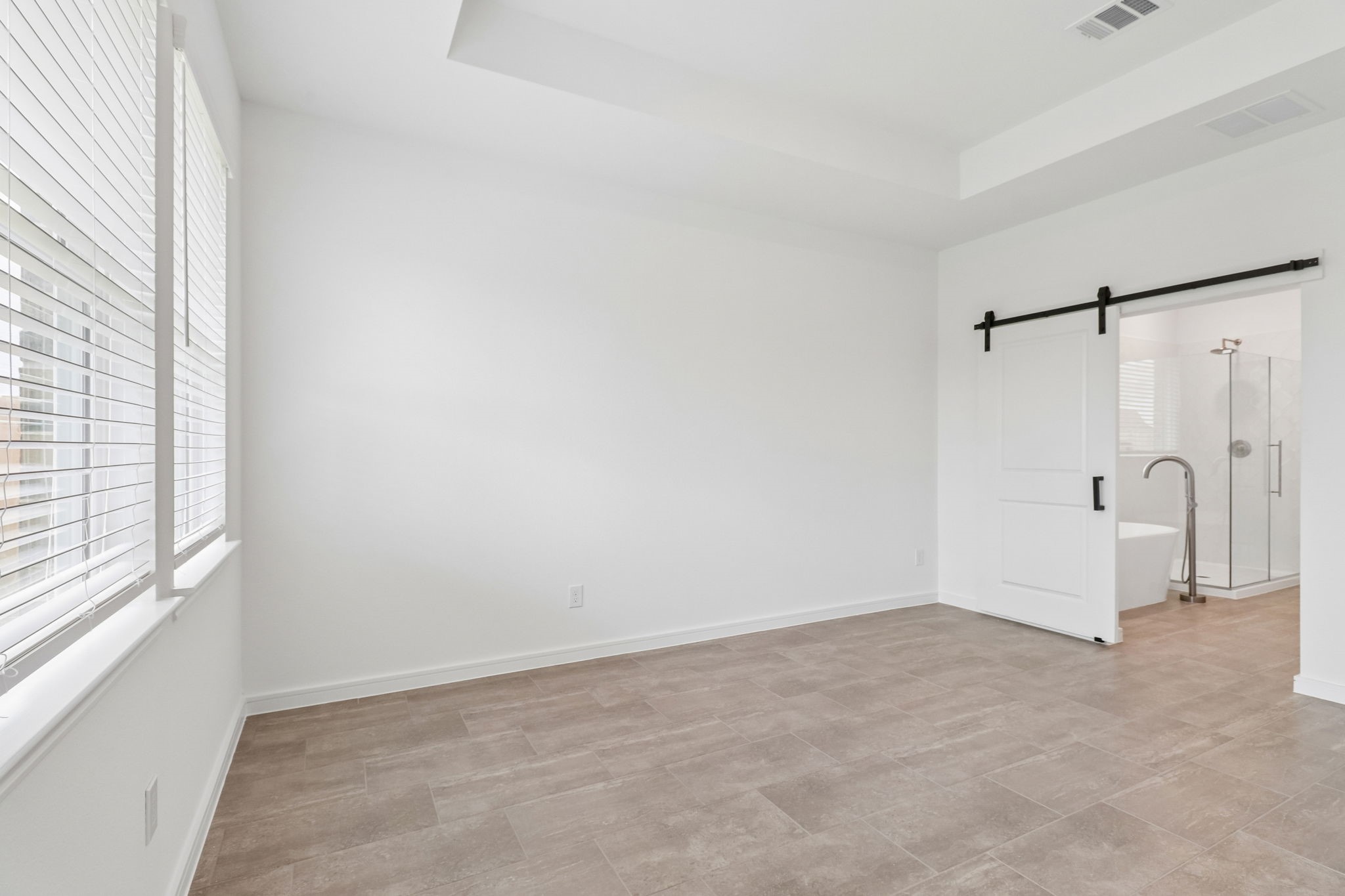 Sliding doors lead to primary bathroom