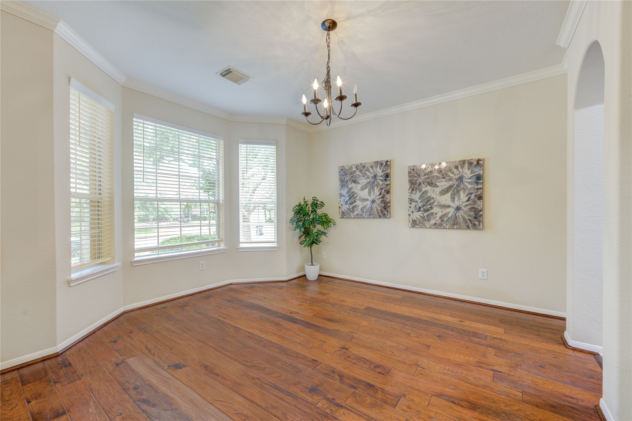 Elegant formal dining room crown molding and oversized windows perfect for hosting gatherings.