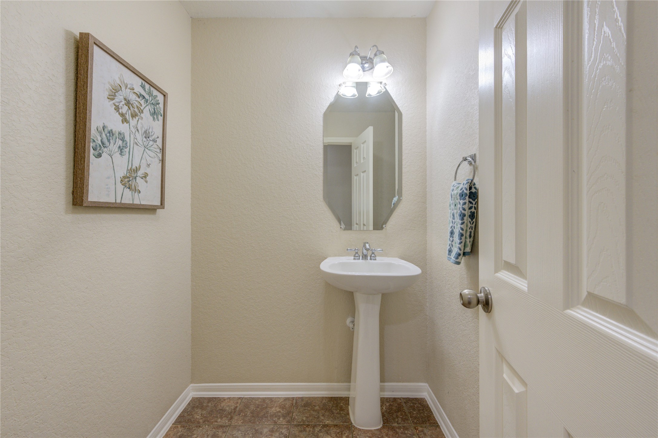 Charming half bath ideally located for guests with a clean and functional design.