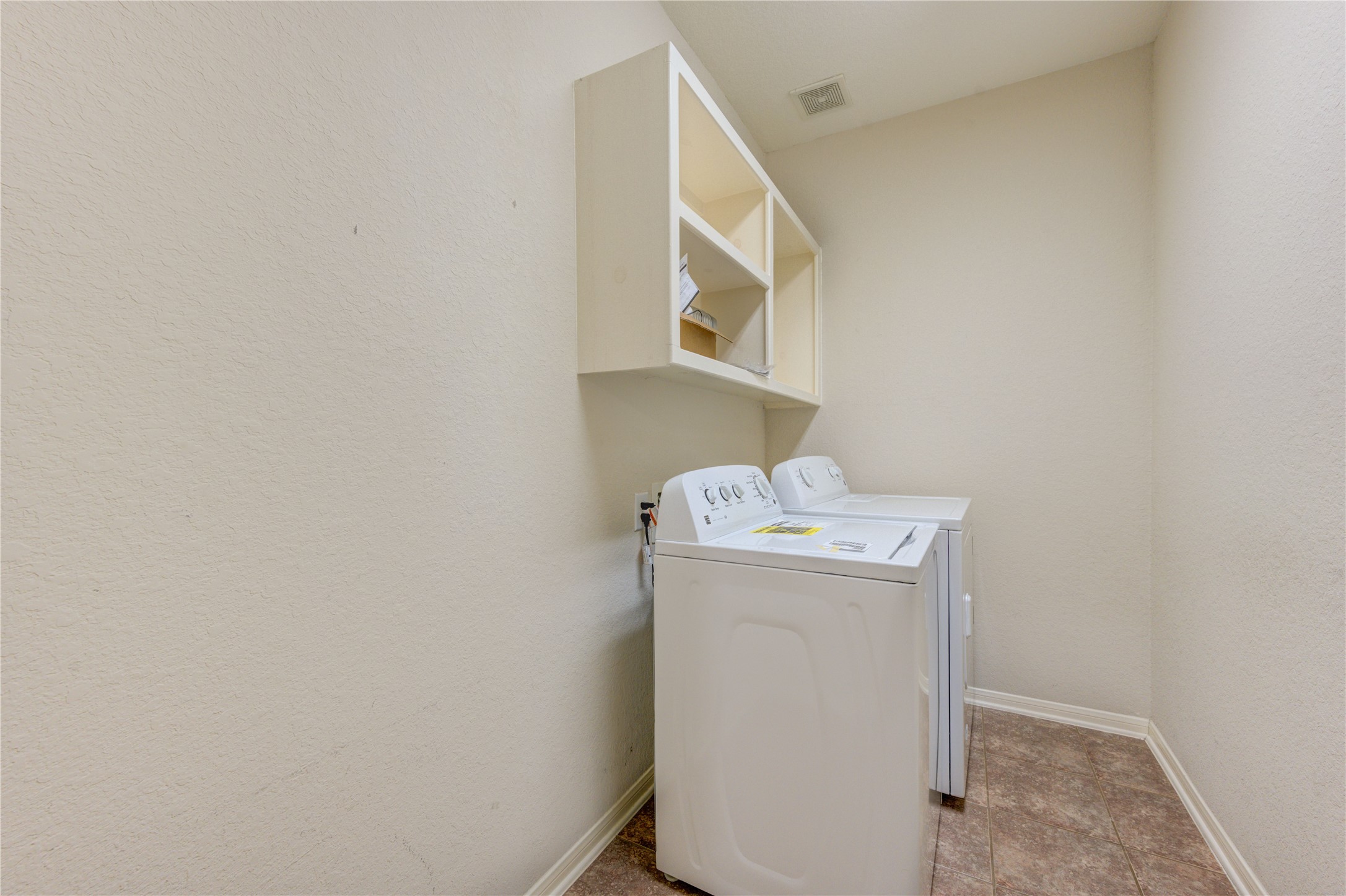 Utility room with built-in shelving and extra storage to keep everyday tasks organized and convenient.