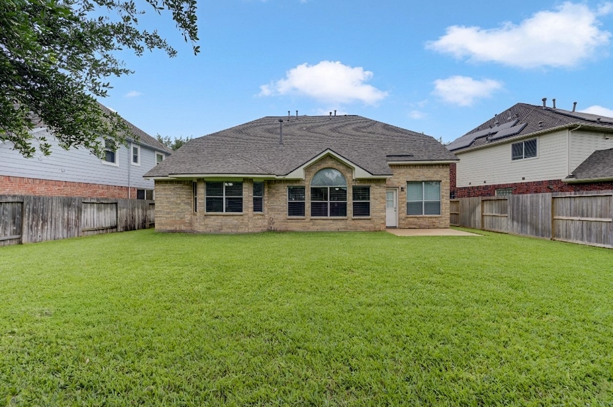 Expansive backyard with plenty of green space, ideal for outdoor entertaining, play, or future pool plans