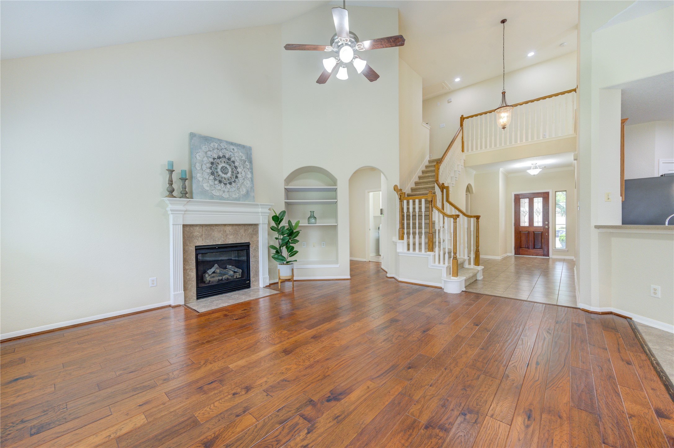 Stunning open-concept living area with dramatic two-story ceilings and an elegant staircase that makes a beautiful first impression. Stunning open-concept living area with dramatic two-story ceilings and an elegant staircase that makes a beautiful first impression.