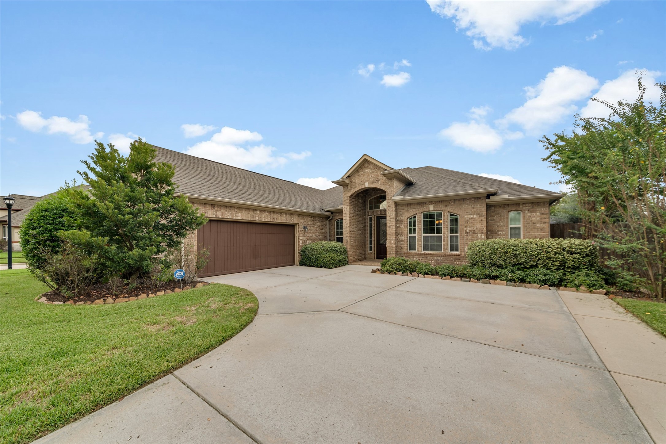 Charming single-story brick home on a corner lot with a spacious driveway and no backyard neighbors.