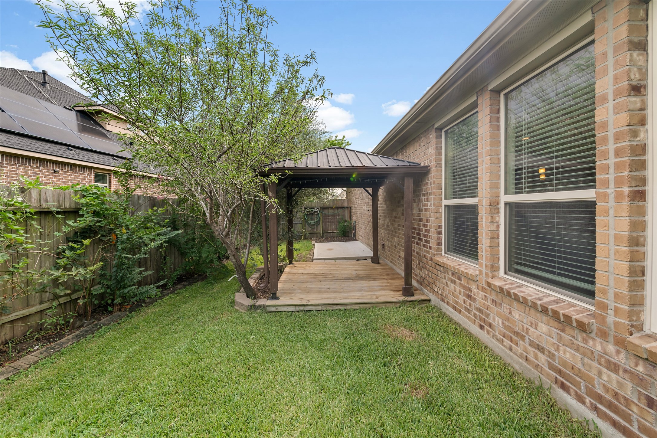Cozy pergola-covered deck, perfect for outdoor relaxation and entertainment.