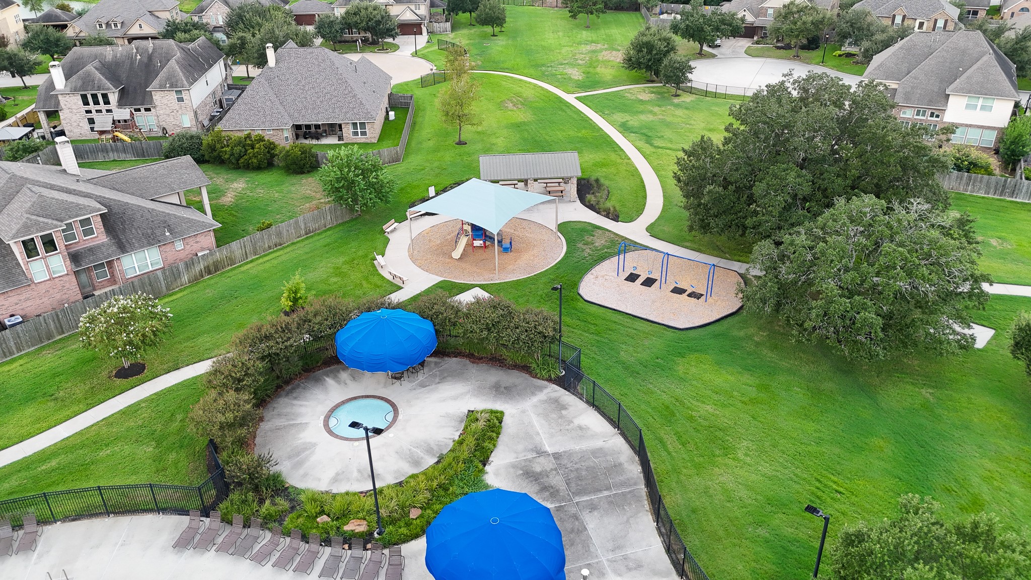 View of kiddie pool, playground, and picnic area.