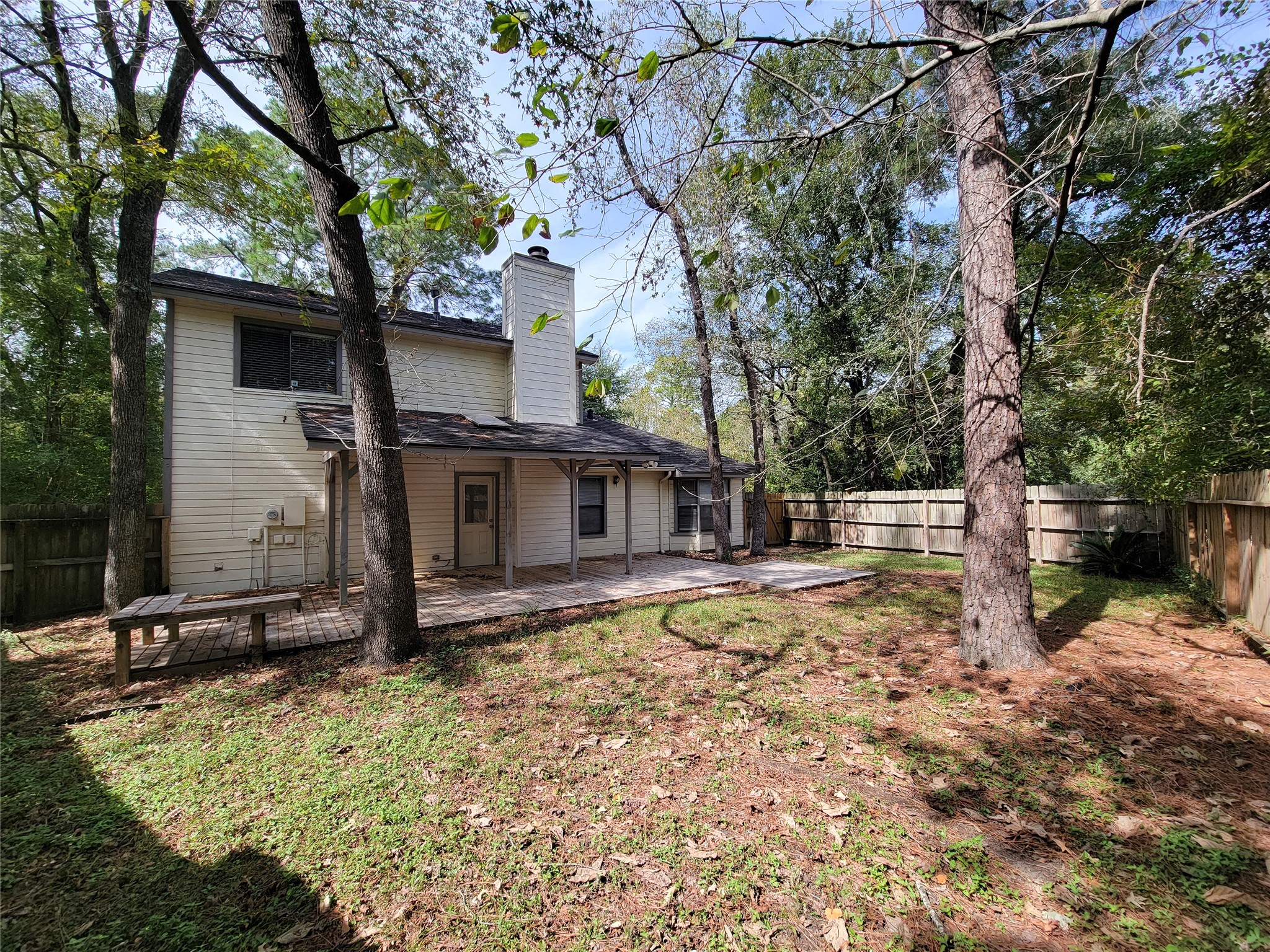 Spacious backyard with mature trees and a charming two-story home, featuring a cozy patio area perfect for outdoor gatherings. Spacious backyard with mature trees and a charming two-story home, featuring a cozy patio area perfect for outdoor gatherings.