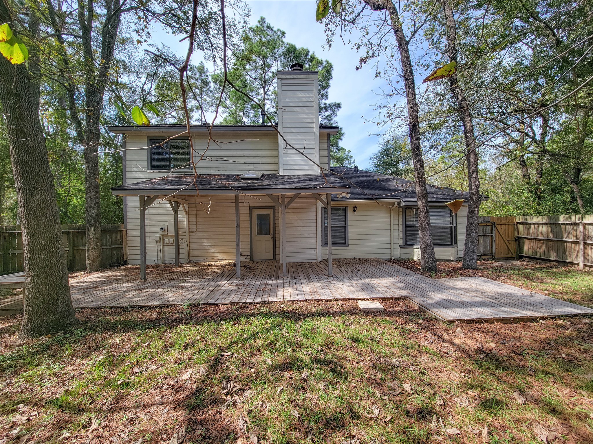 Charming two-story home with a spacious wooden deck, nestled in a serene wooded backyard, perfect for outdoor gatherings and relaxation. Charming two-story home with a spacious wooden deck, nestled in a serene wooded backyard, perfect for outdoor gatherings and relaxation.